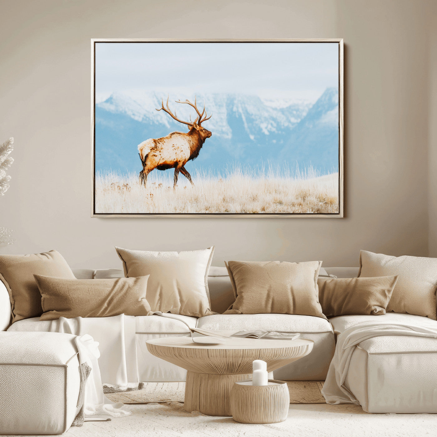 Majestic elk standing on dry grassland with snowy mountains in the background, ideal for rustic or lodge-inspired wall decor.