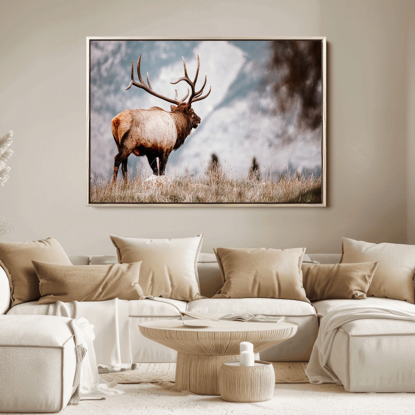 Majestic elk with large antlers standing in grass with snowy mountains in background, perfect for rustic cabin or lodge style decor.