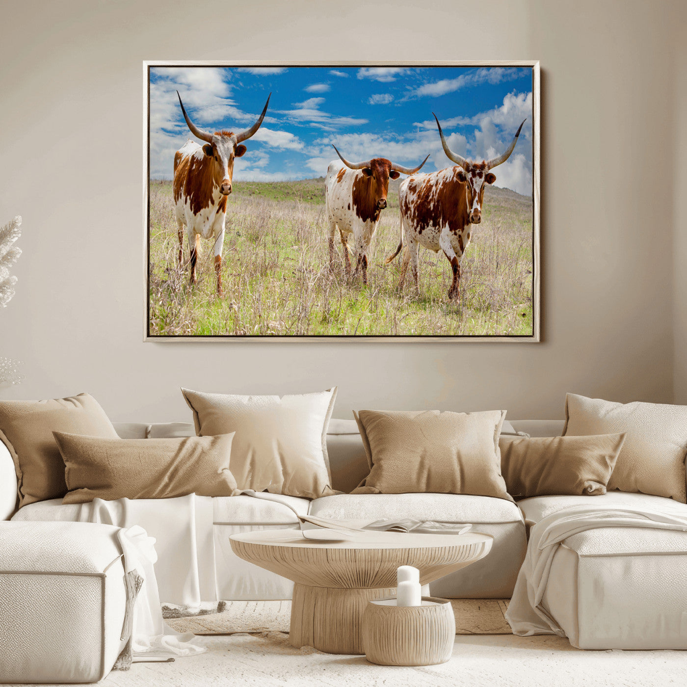 Three Texas longhorn cattle standing in dry grass under a bright blue sky, ideal for farmhouse or western rustic home decor.