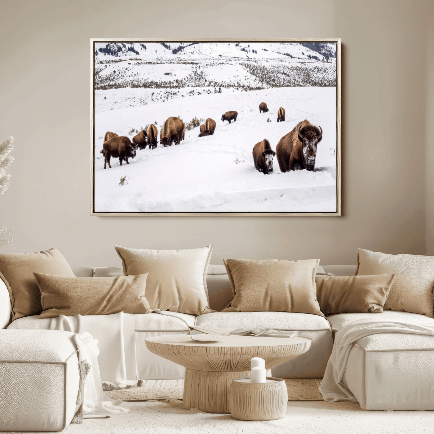 A herd of bison walking through deep snow in a mountain valley, perfect for rustic, cabin or western-themed wall decor.