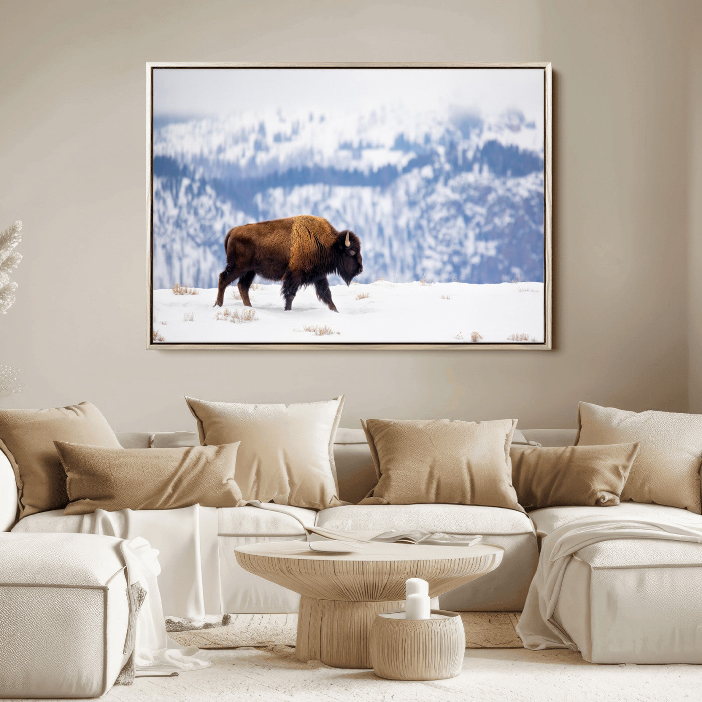 A lone bison walks across snowy ground with blue-toned mountain range behind, ideal for rustic or western farmhouse interiors.