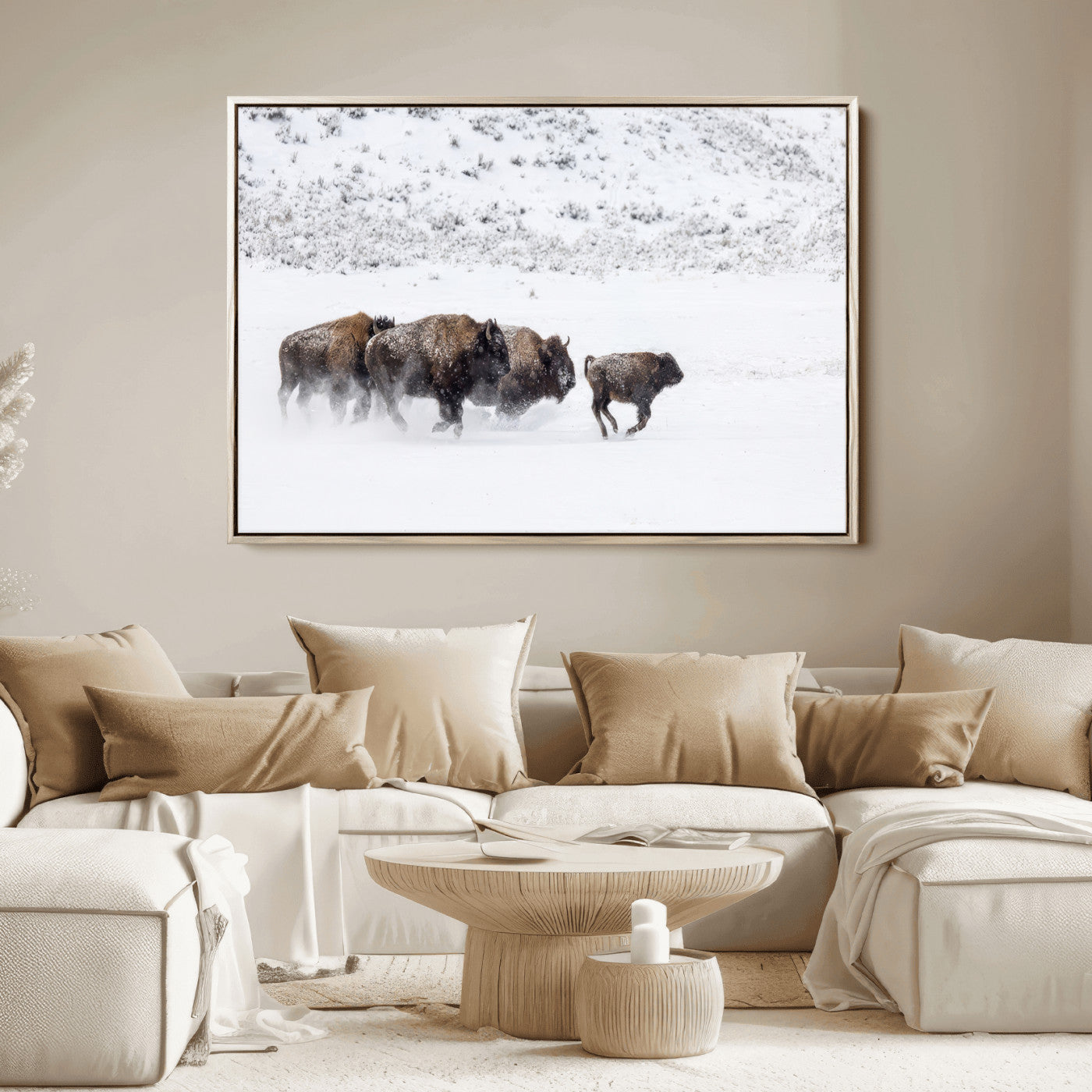 Bison herd running through a snowy open field with mountain backdrop, perfect for rustic or western-themed wall decoration.