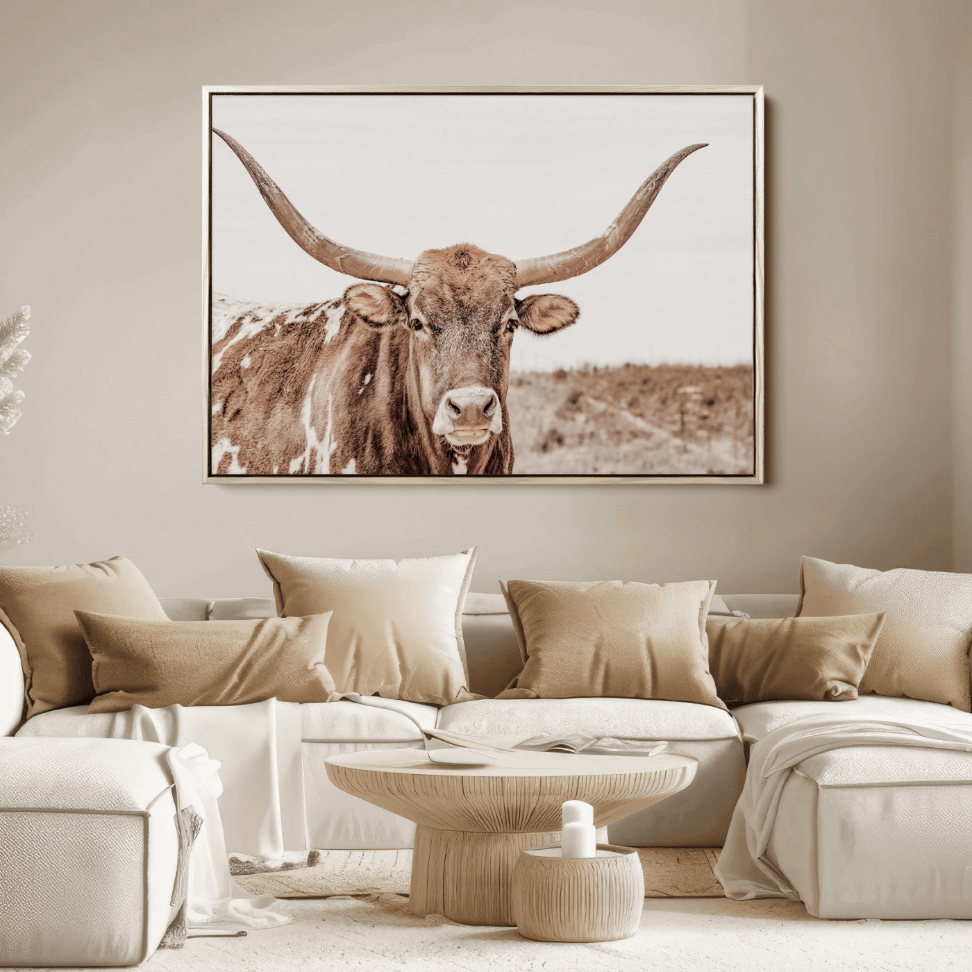 A longhorn cow in soft beige desert tones, standing calmly in open land, perfect for neutral western or rustic farmhouse interiors.