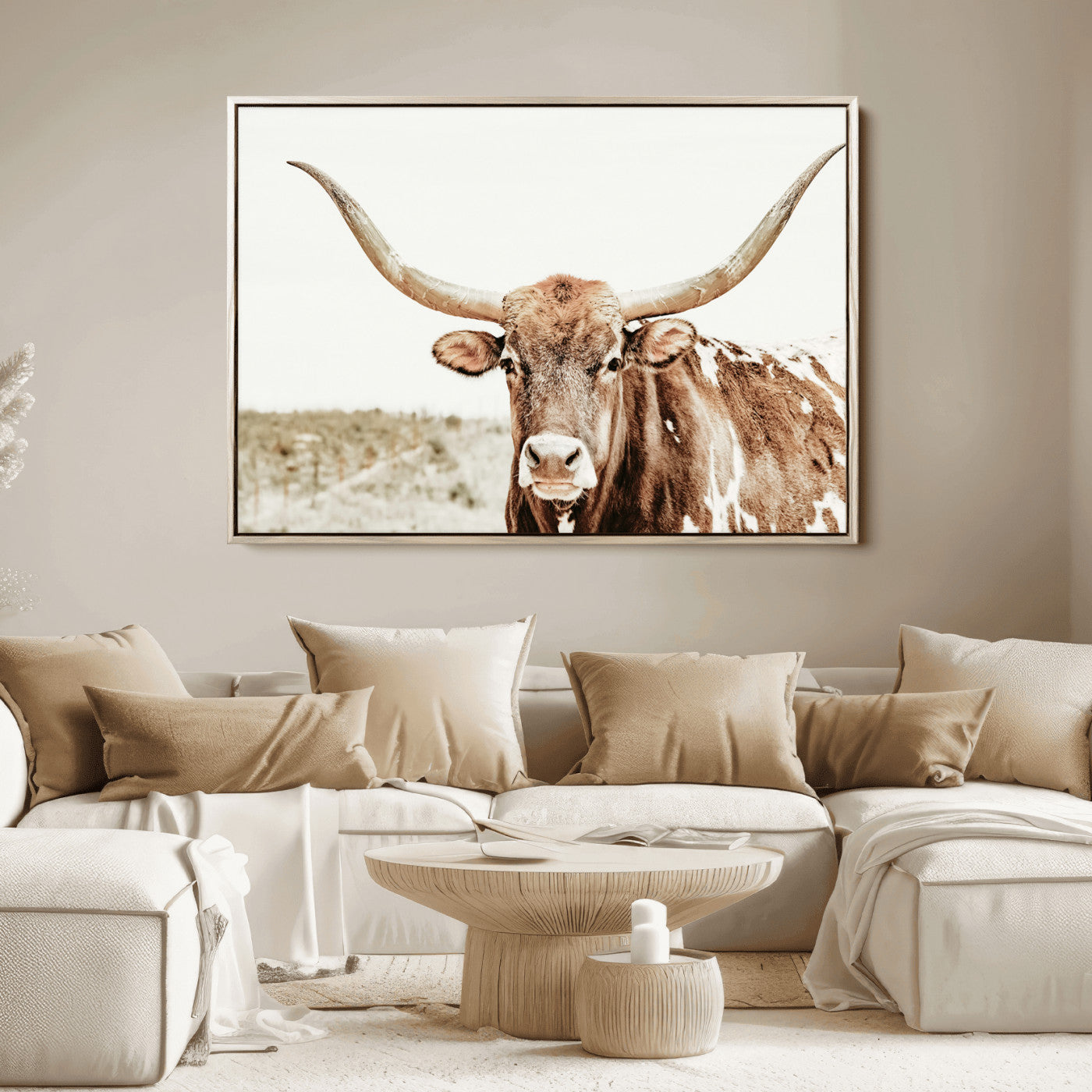 A Texas longhorn bull with wide horns, standing in a dry field under soft light, ideal for rustic farmhouse or western-themed interiors.