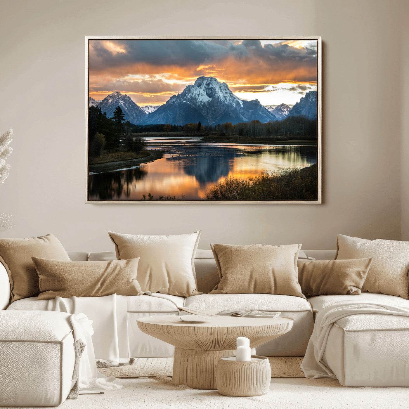 Snow-capped mountains reflecting in a calm lake at sunset, with a dramatic golden sky creating a breathtaking wilderness scene.