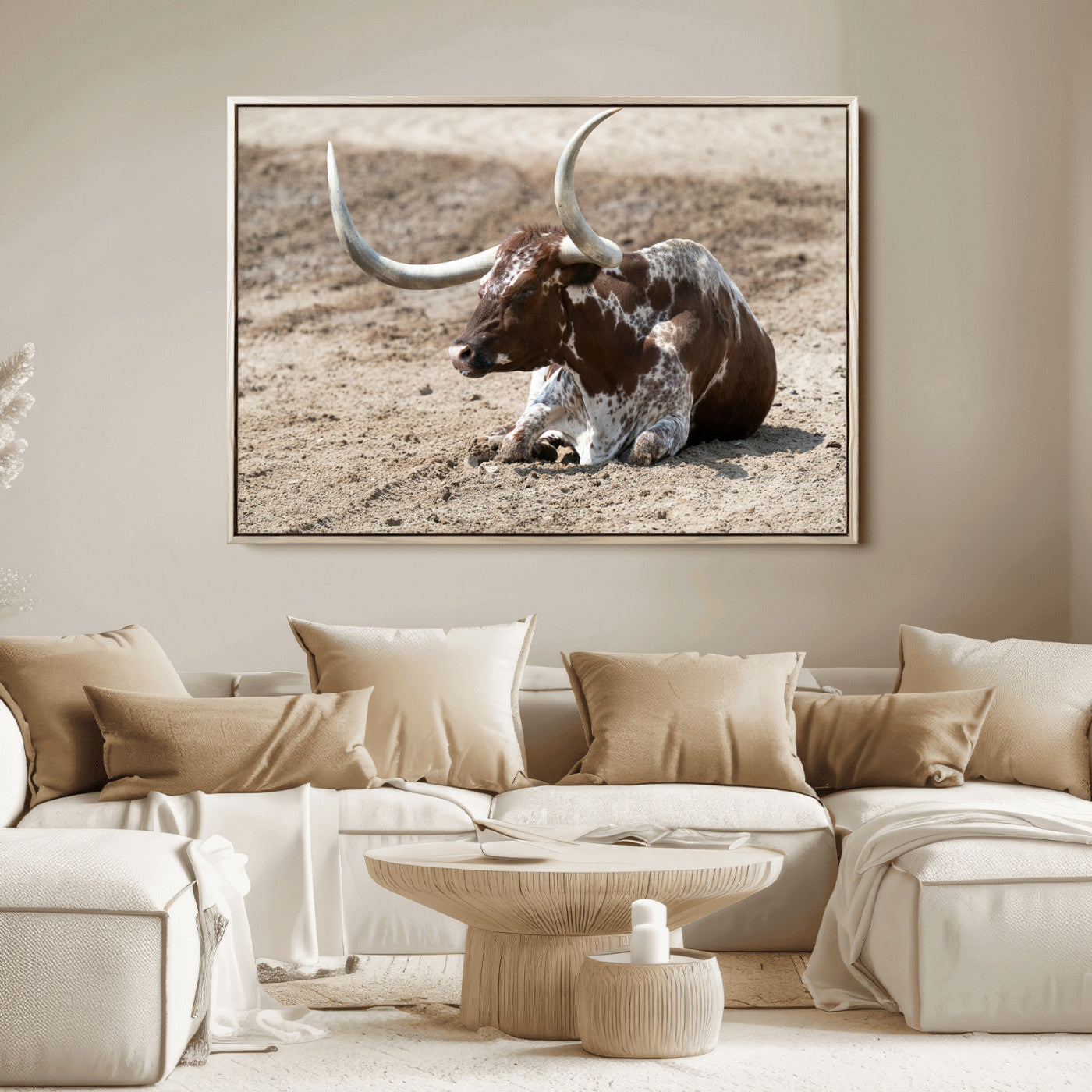 Texas Longhorn resting on sandy ground with large curved horns, capturing a rustic Western aesthetic perfect for farmhouse-style wall art.