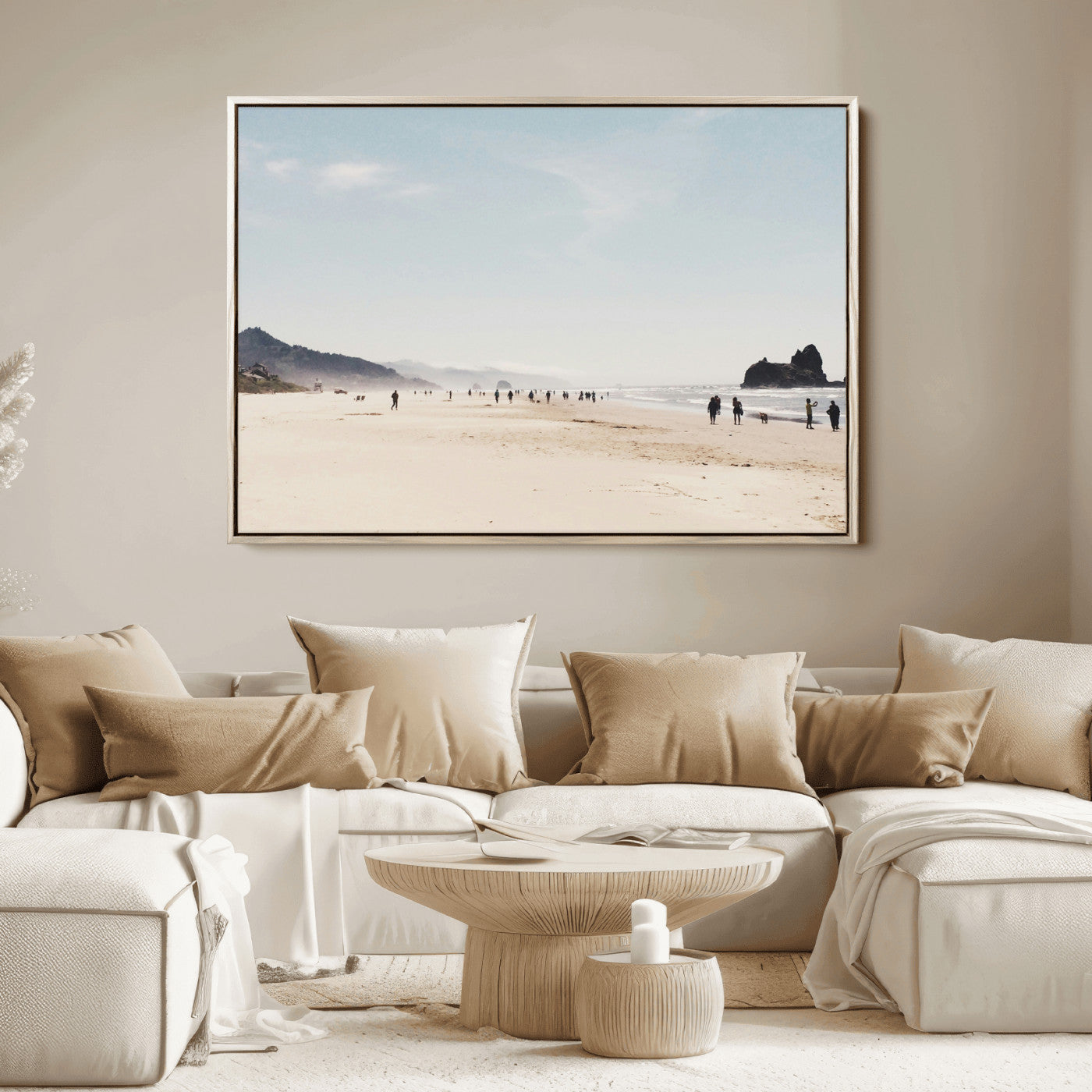 A serene beach with soft sand, misty mountains, and scattered people walking along the shoreline, creating a peaceful coastal landscape.