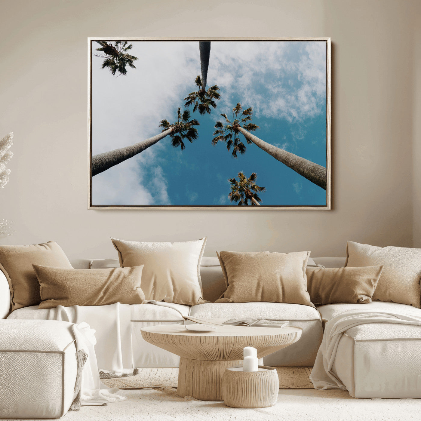 Looking up at tall palm trees against a bright blue sky with scattered clouds, creating a tropical and airy atmosphere for modern home decor.