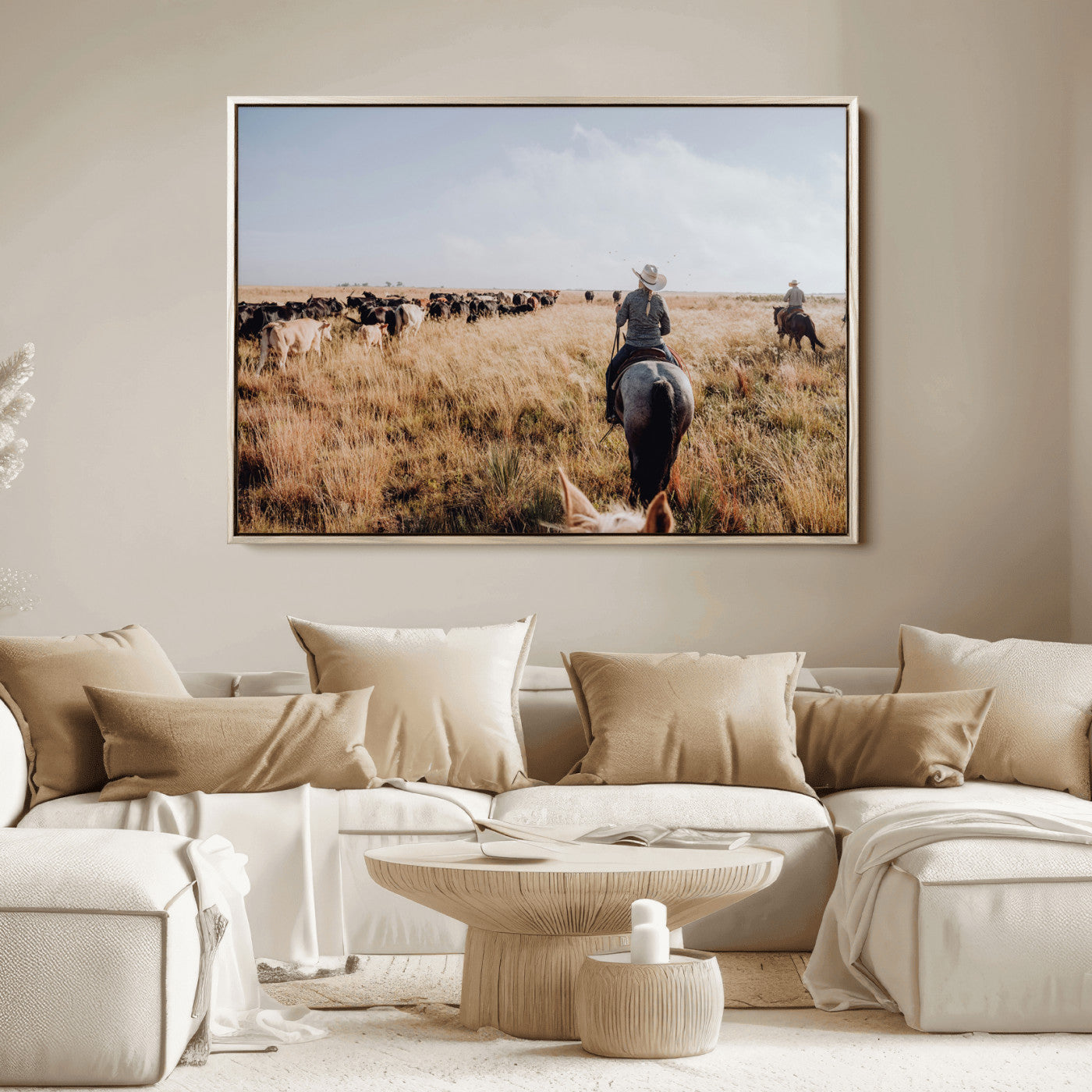 A cowboy and cowgirl on horseback herding cattle through golden grasslands, capturing a rustic and authentic Western ranch lifestyle.