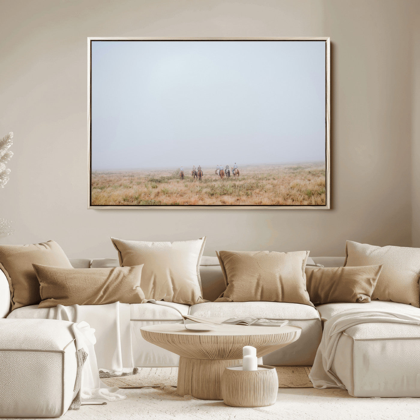 A group of horseback riders moving through a fog-shrouded field, evoking a calm Western scene with golden grasses and soft horizons.