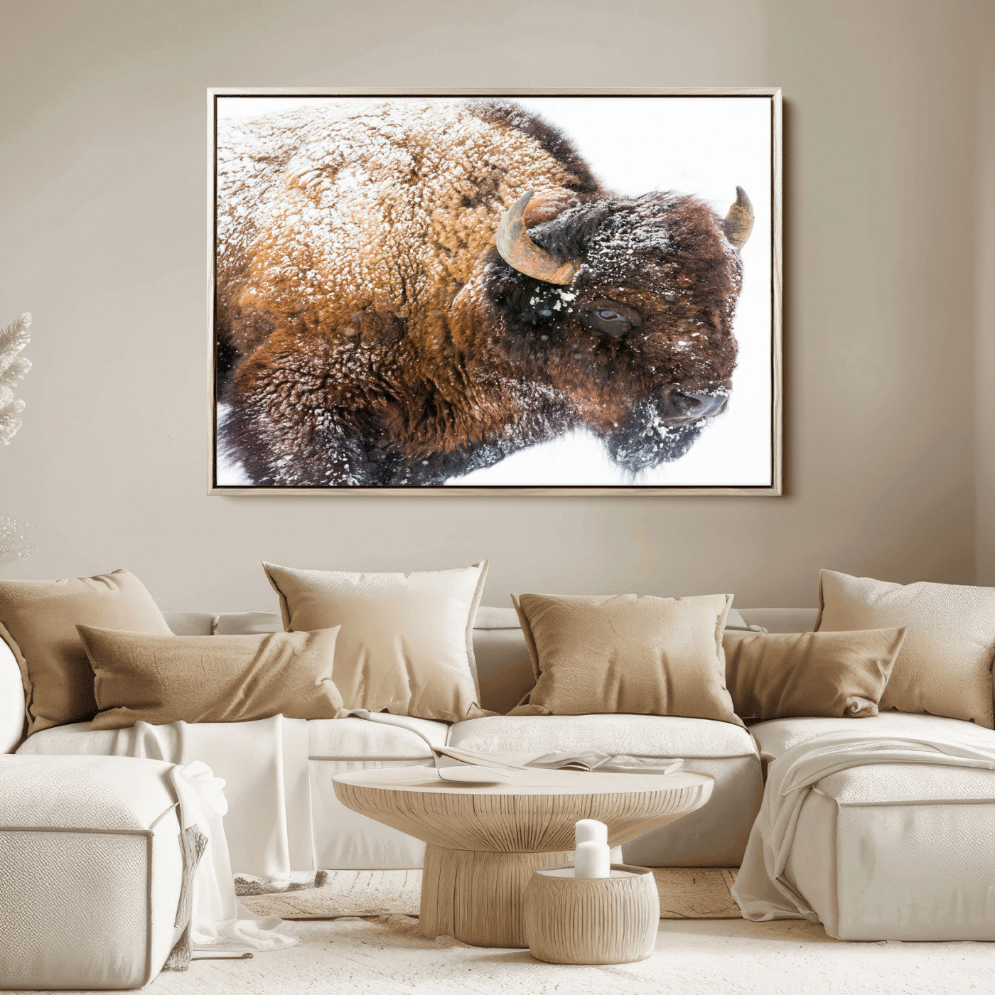 Close-up photograph of a bison covered in snow, highlighting its thick fur and powerful presence, set against a white winter backdrop, ideal for rustic decor.