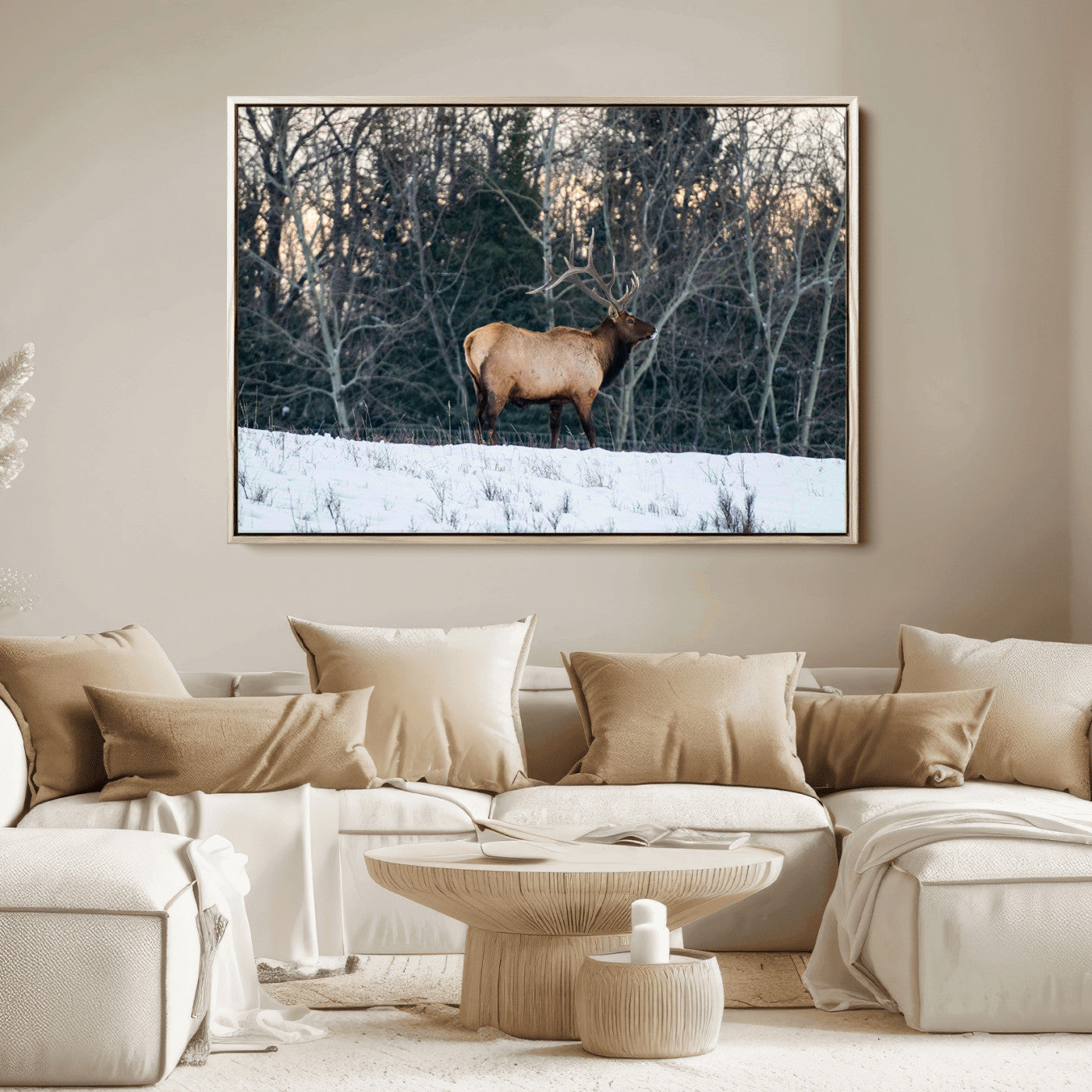 A majestic elk with large antlers standing in a snowy field against a winter forest backdrop, perfect for rustic and wildlife-themed home decor.