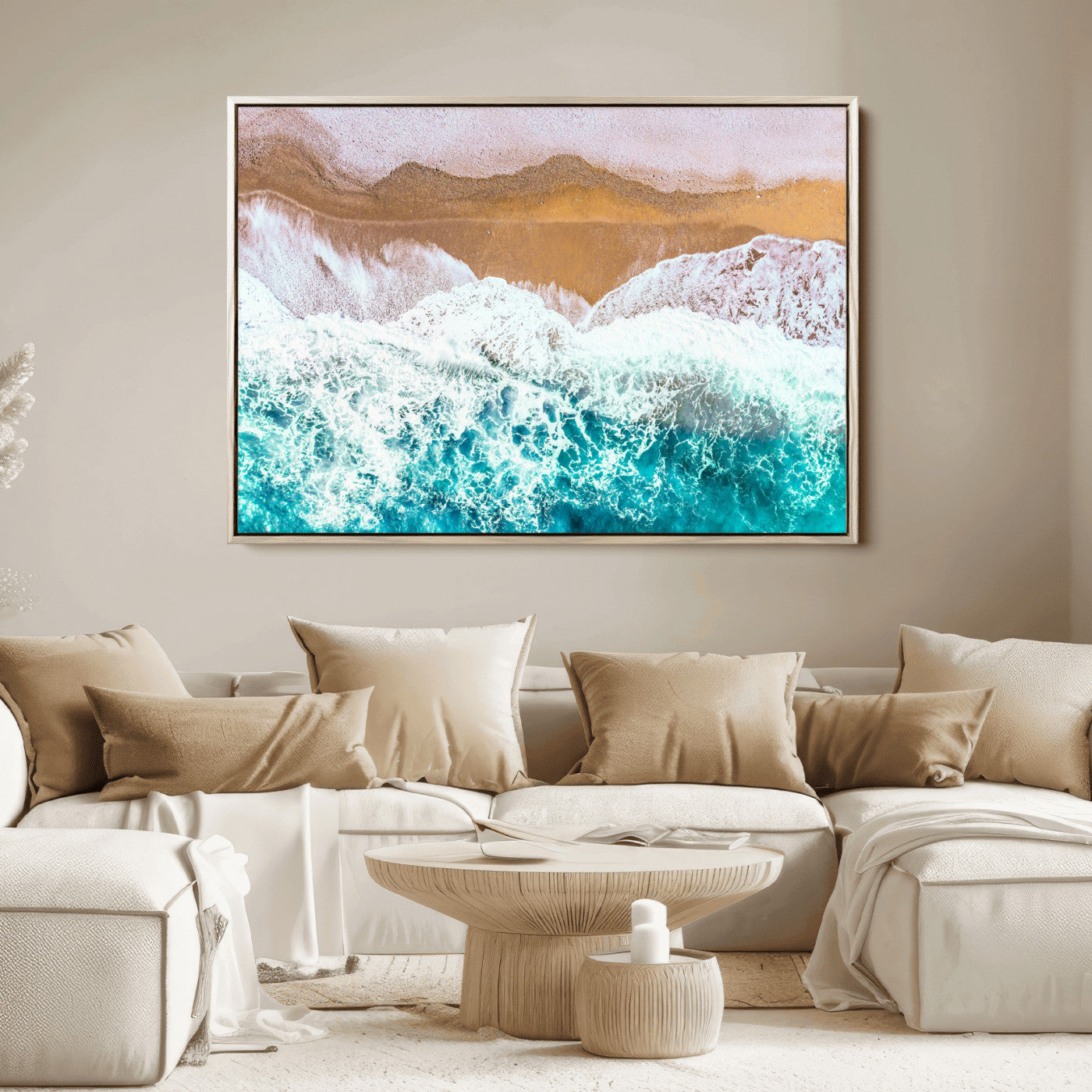 Aerial view of ocean waves crashing onto a sandy beach, with turquoise water and foamy white surf, creating a serene coastal aesthetic for home decor.