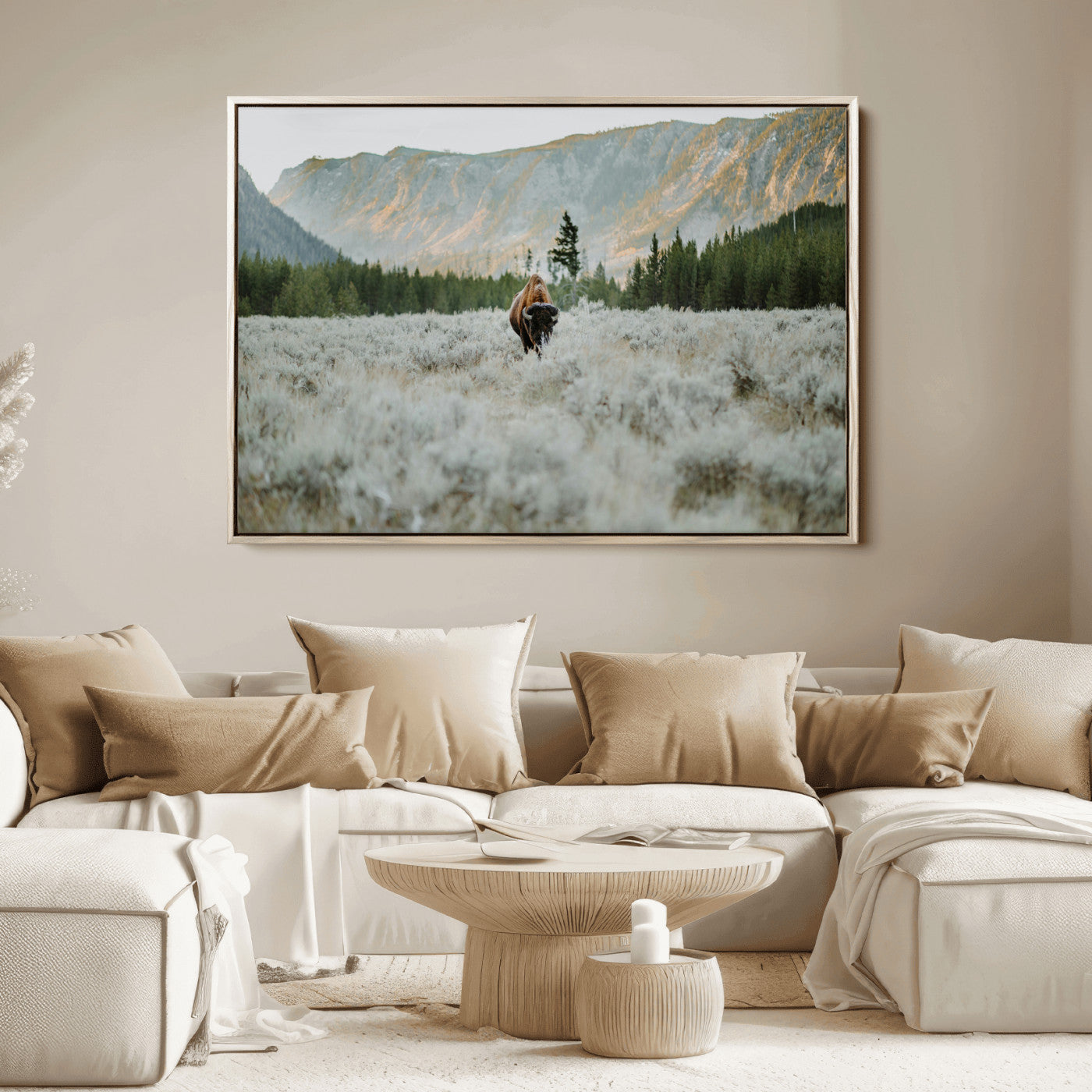 Lone bison standing in a frosted sagebrush field with a pine forest and rugged mountain range in the background under soft morning light – Wall Art Canvas Print.