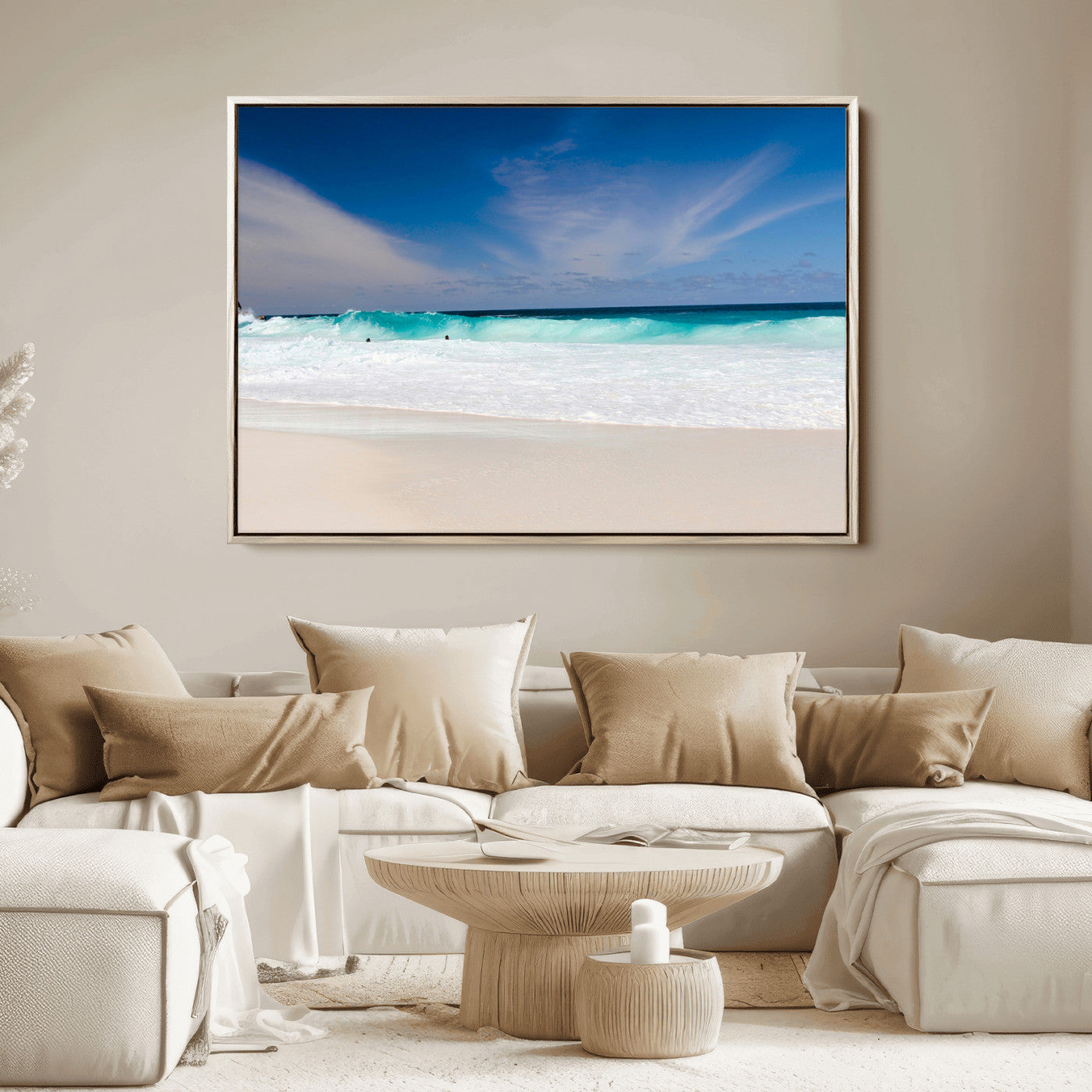Turquoise waves crash onto a pristine white sand beach under a vivid blue sky with wispy clouds, creating a peaceful and refreshing coastal scene.