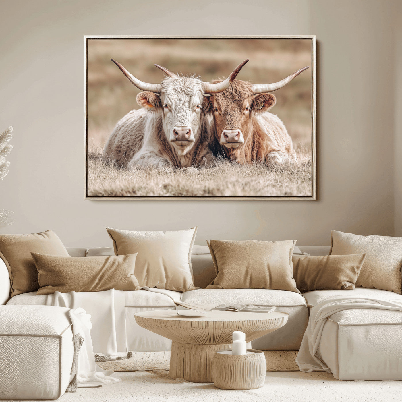 Two Highland cows with long horns lying side by side on a grassy field, featuring soft natural tones and a calm rural setting.
