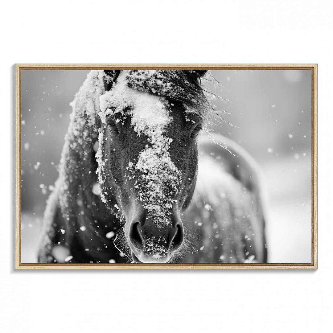 The Black and White Horse Winter Wall Art features a majestic horse with snow-covered hair set against a serene winter backdrop.