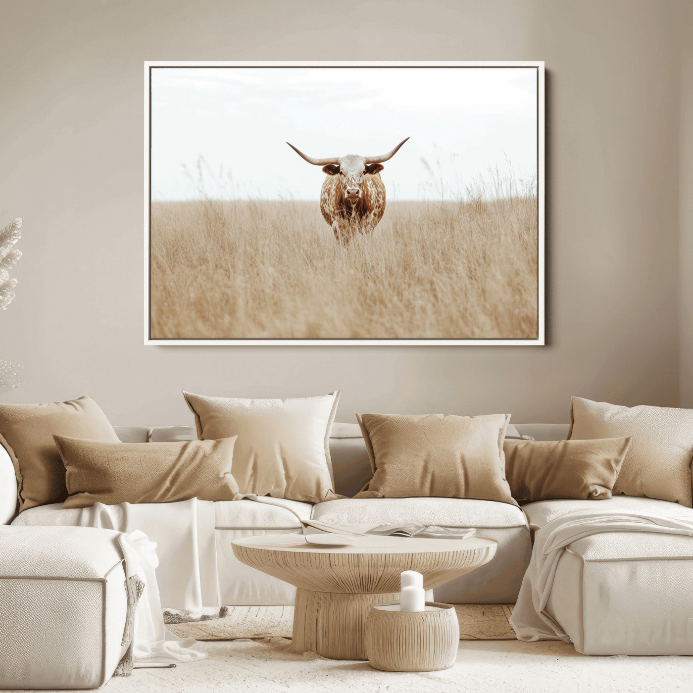 Texas Longhorn bull standing alone in dry grass with neutral tones, ideal for rustic western or cowboy-themed wall decor.