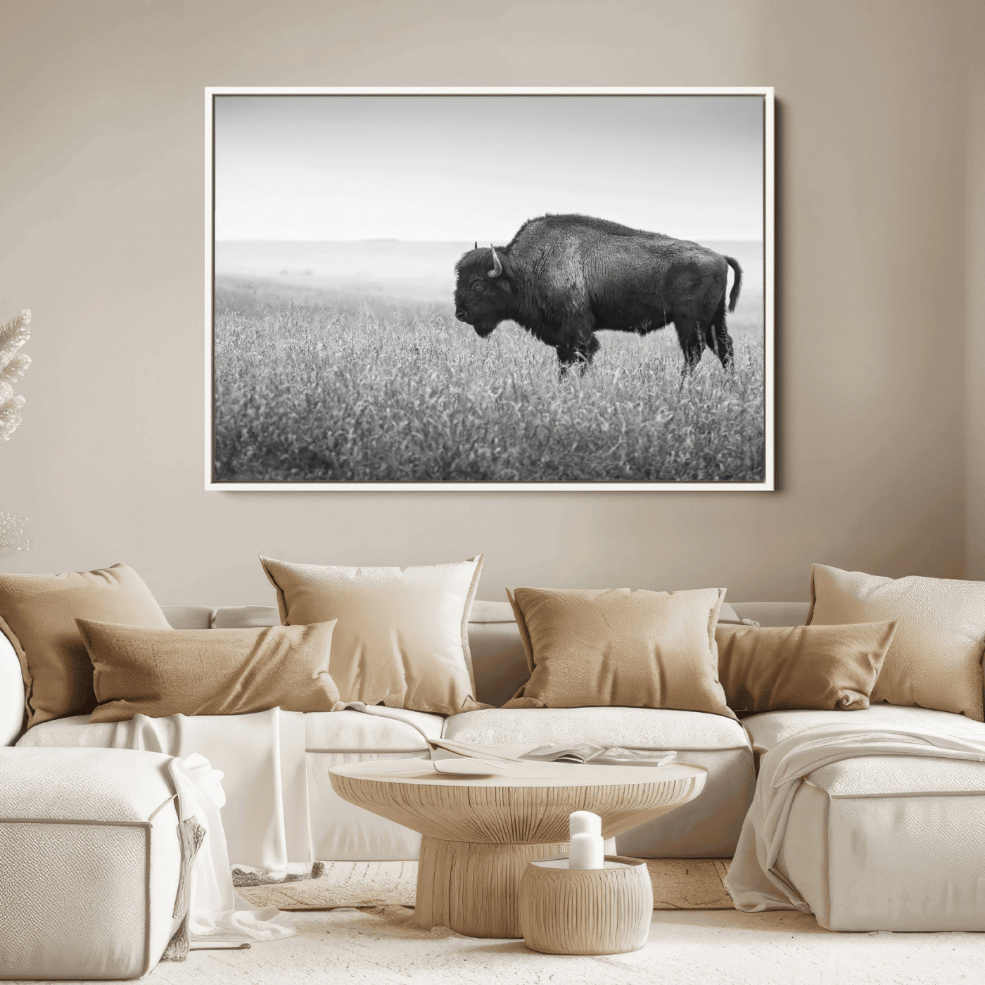 A black and white photograph of a majestic bison standing in a vast grassy prairie, evoking a sense of wilderness and strength.