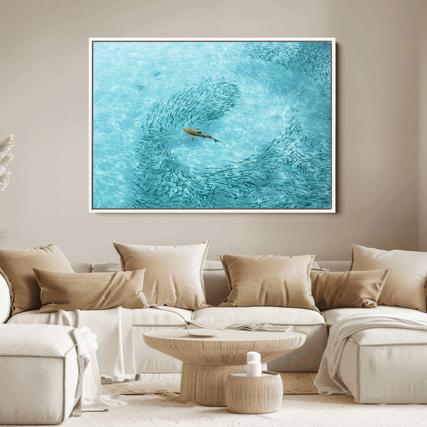 Aerial view of a shark swimming through a swirl of fish in clear turquoise waters, perfect for calm coastal or beach house decor.