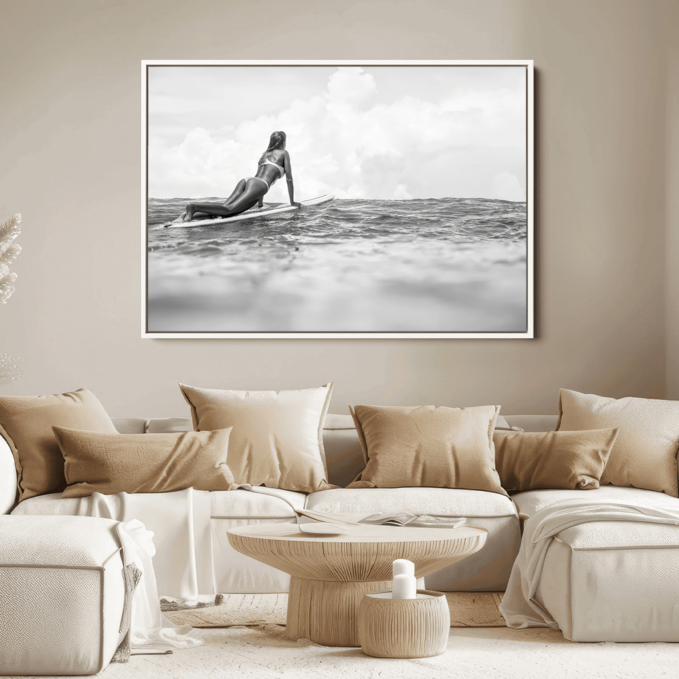 A black and white ocean scene featuring a surfer girl waiting on her board, gazing at the horizon, capturing a tranquil and adventurous coastal moment.