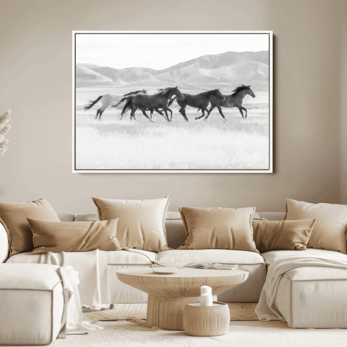 A black and white image of wild horses running freely across an open grassland, capturing the power and beauty of untamed nature in a rustic western setting.