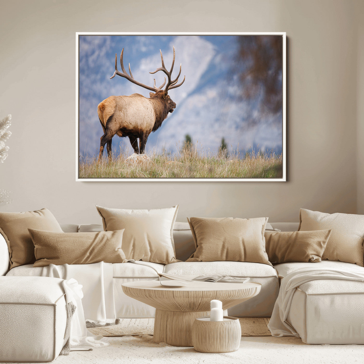 Elk with antlers standing on grass with mountain background, ideal for rustic, cabin, or lodge-inspired wall decor.