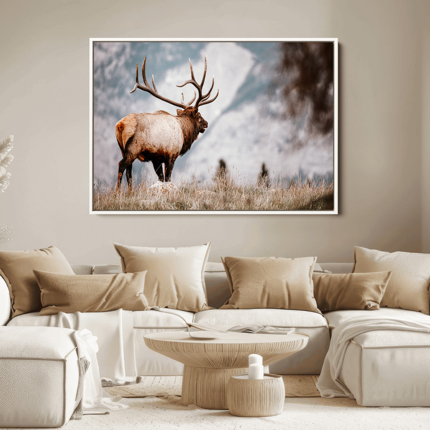 Majestic elk with large antlers standing in grass with snowy mountains in background, perfect for rustic cabin or lodge style decor.