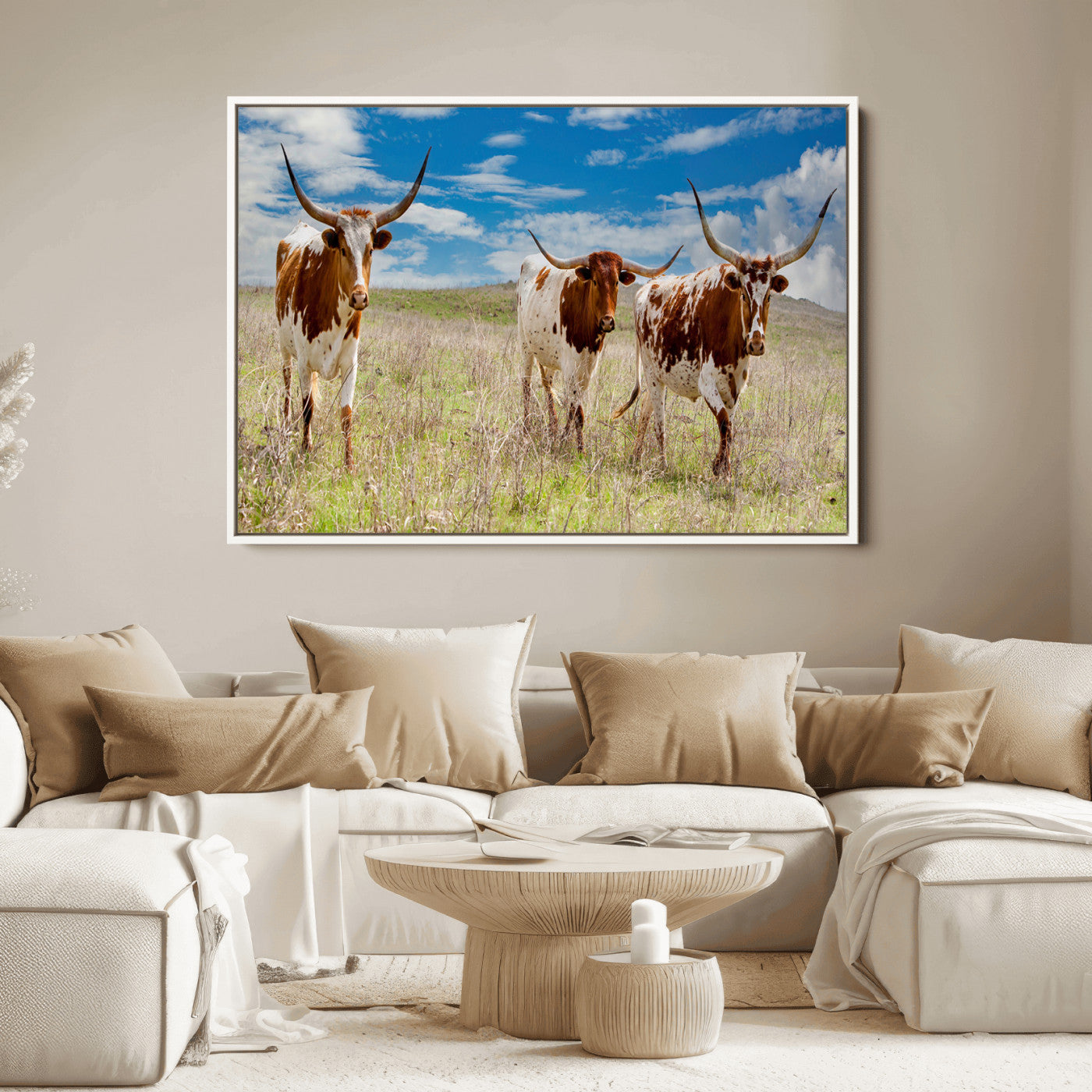 Three Texas longhorn cattle standing in dry grass under a bright blue sky, ideal for farmhouse or western rustic home decor.