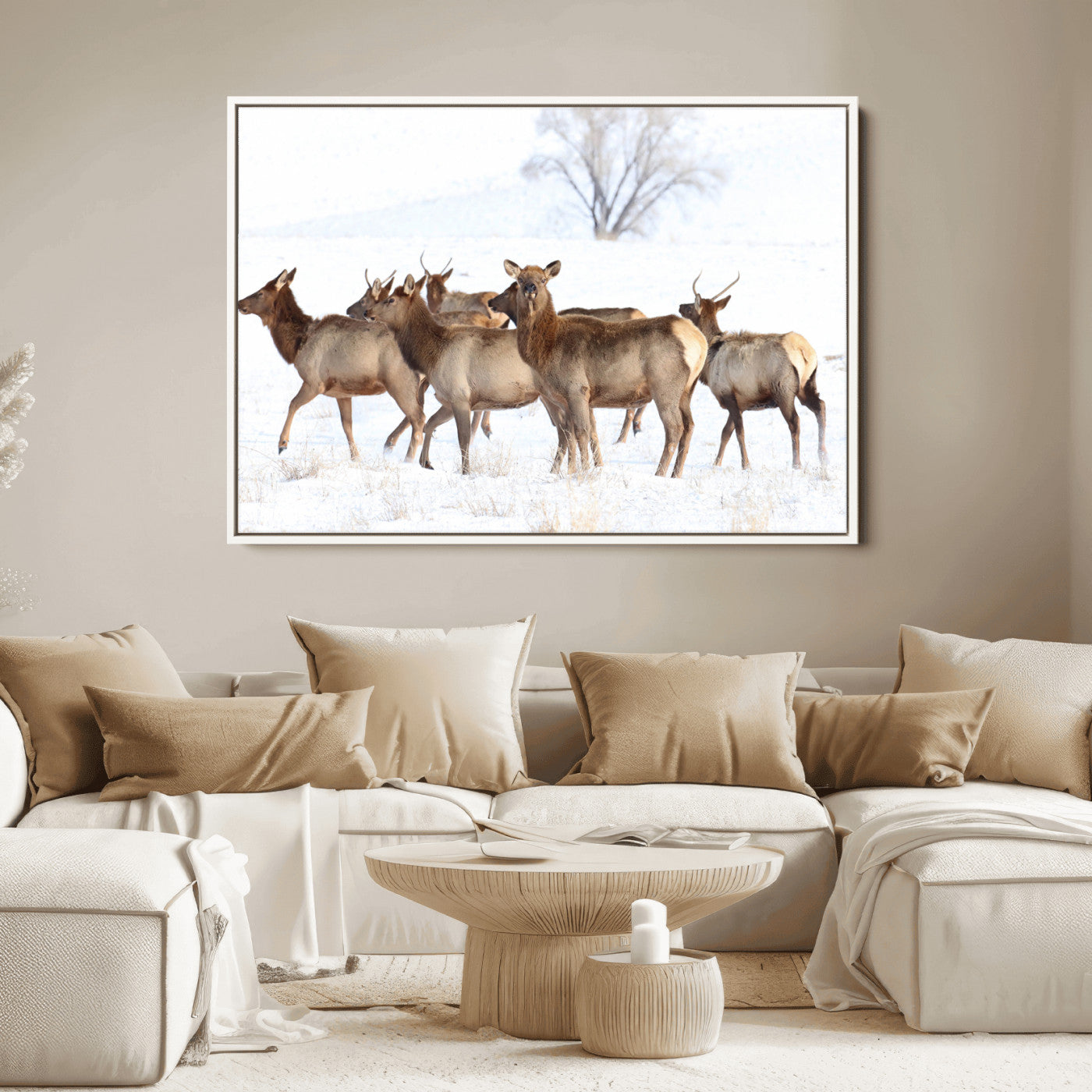 A group of elk standing on snowy terrain with a tree in the background, perfect for rustic or lodge-style winter wall decor.