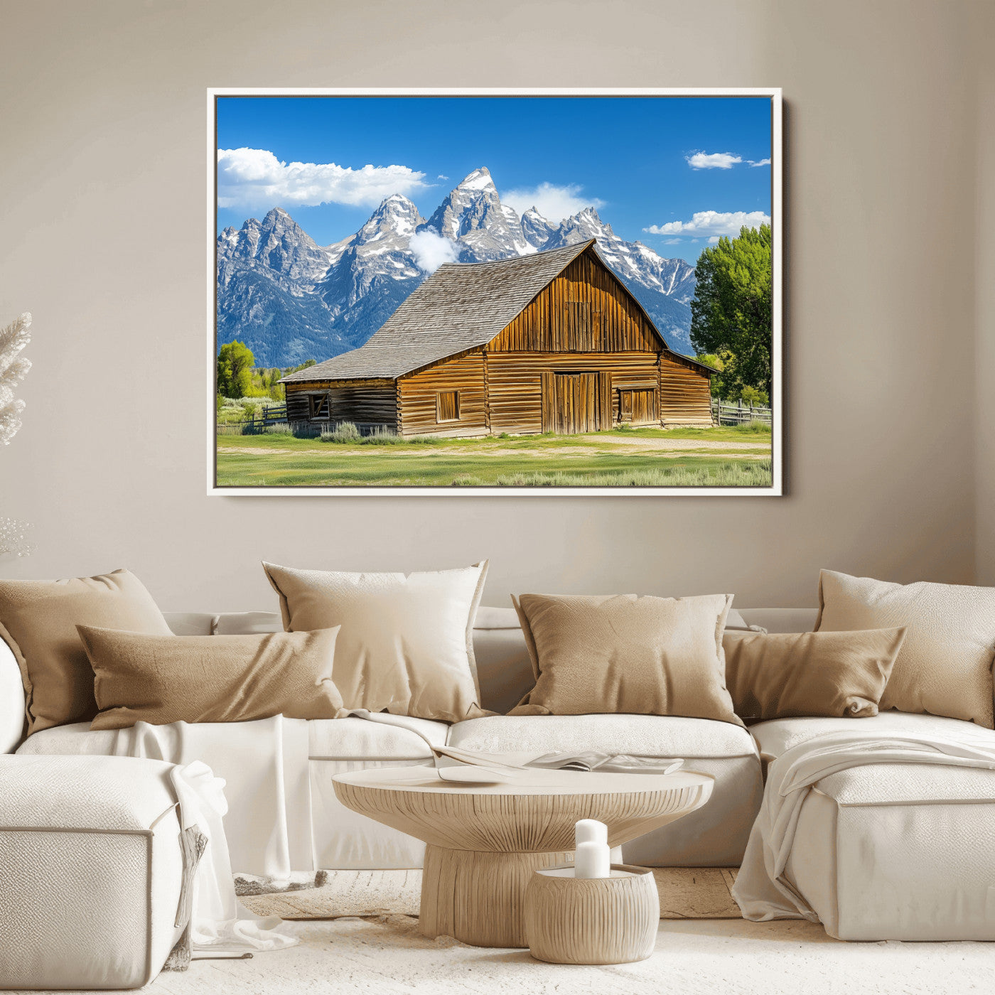 A rustic wooden barn sits in front of towering mountain peaks under a clear blue sky, perfect for farmhouse or cabin style interiors.