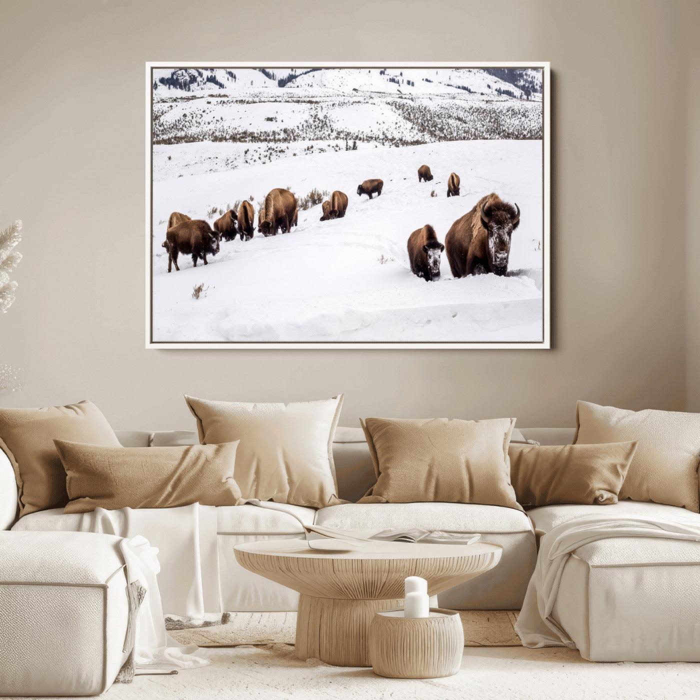 A herd of bison walking through deep snow in a mountain valley, perfect for rustic, cabin or western-themed wall decor.