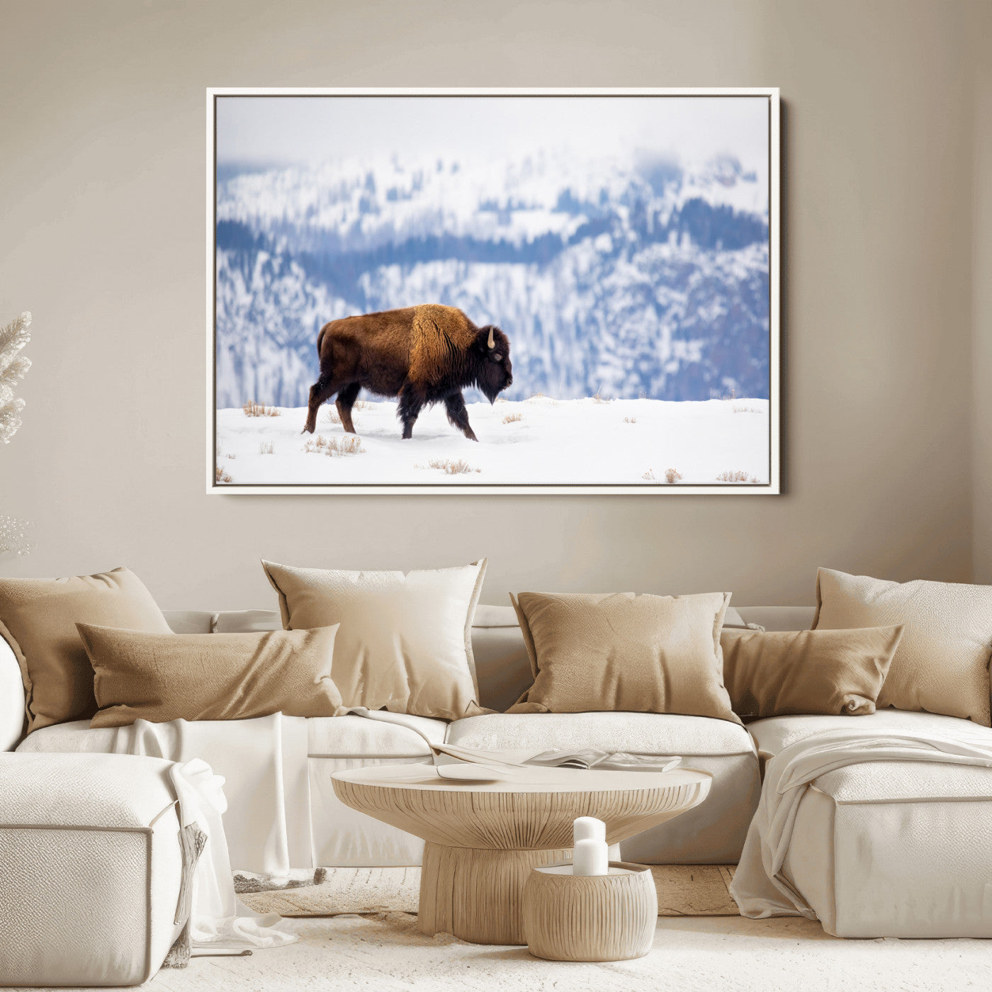 A lone bison walks across snowy ground with blue-toned mountain range behind, ideal for rustic or western farmhouse interiors.