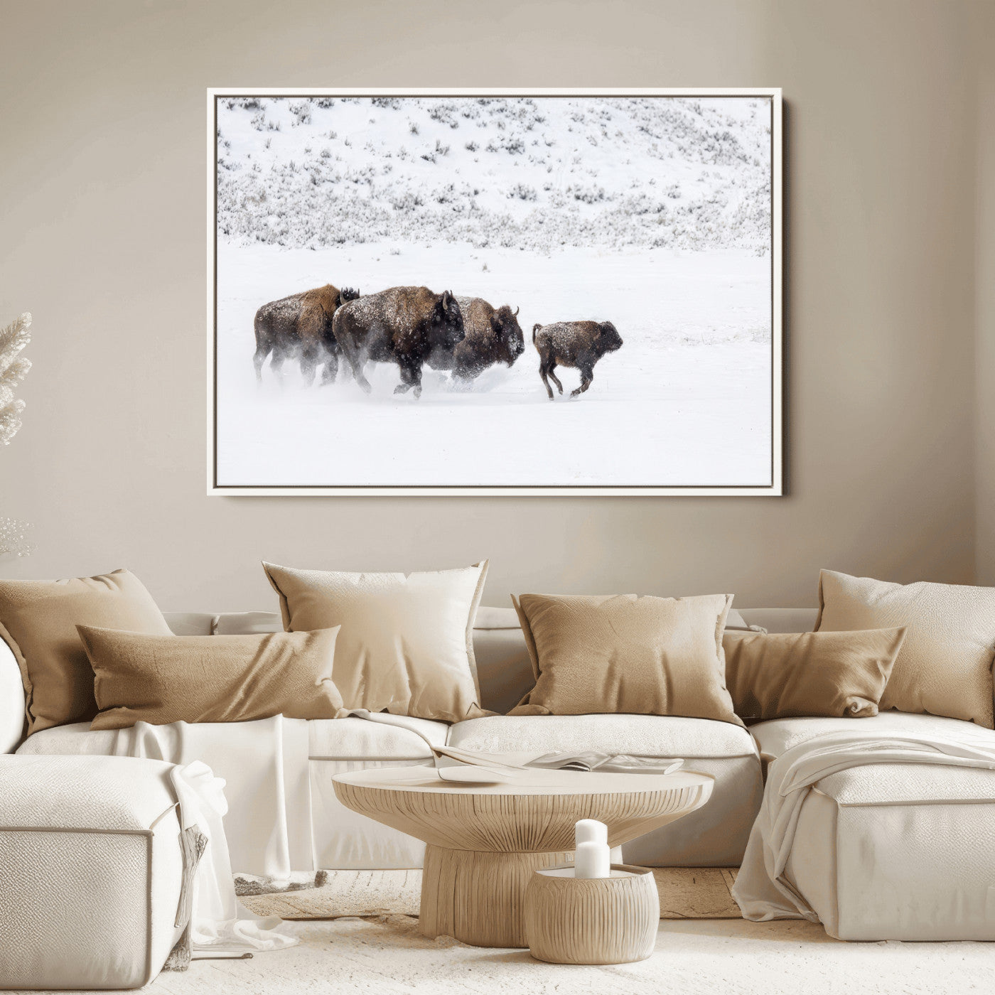 Bison herd running through a snowy open field with mountain backdrop, perfect for rustic or western-themed wall decoration.