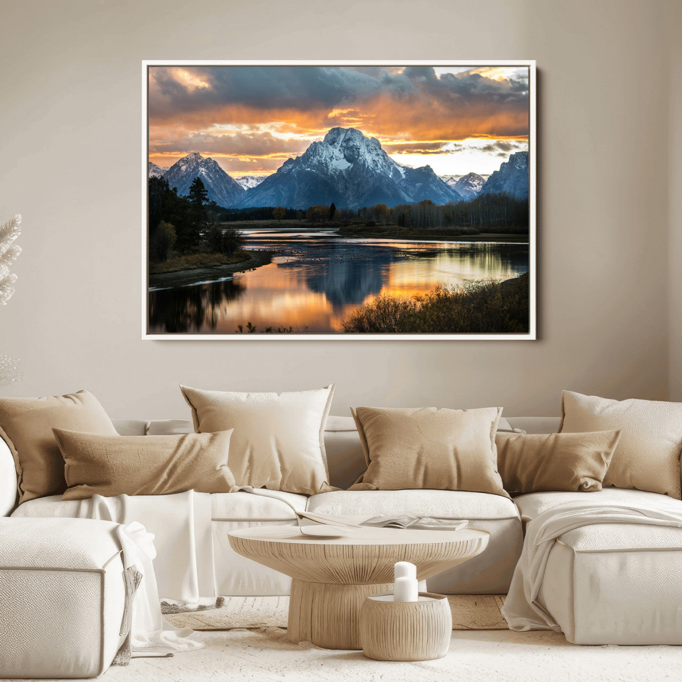Snow-capped mountains reflecting in a calm lake at sunset, with a dramatic golden sky creating a breathtaking wilderness scene.