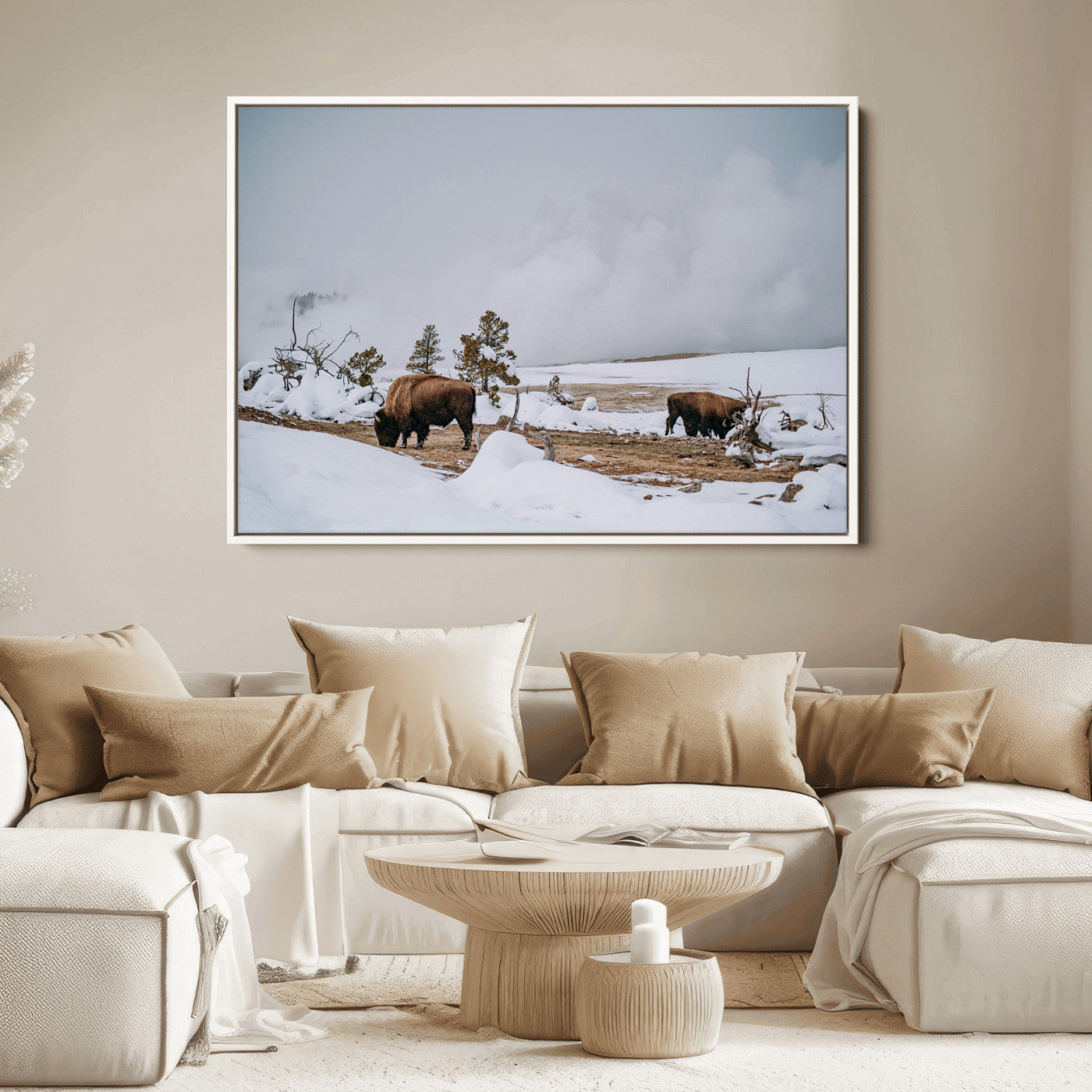 Two bison grazing in a snowy open landscape with misty hills in the background, creating a peaceful and rustic winter scene.