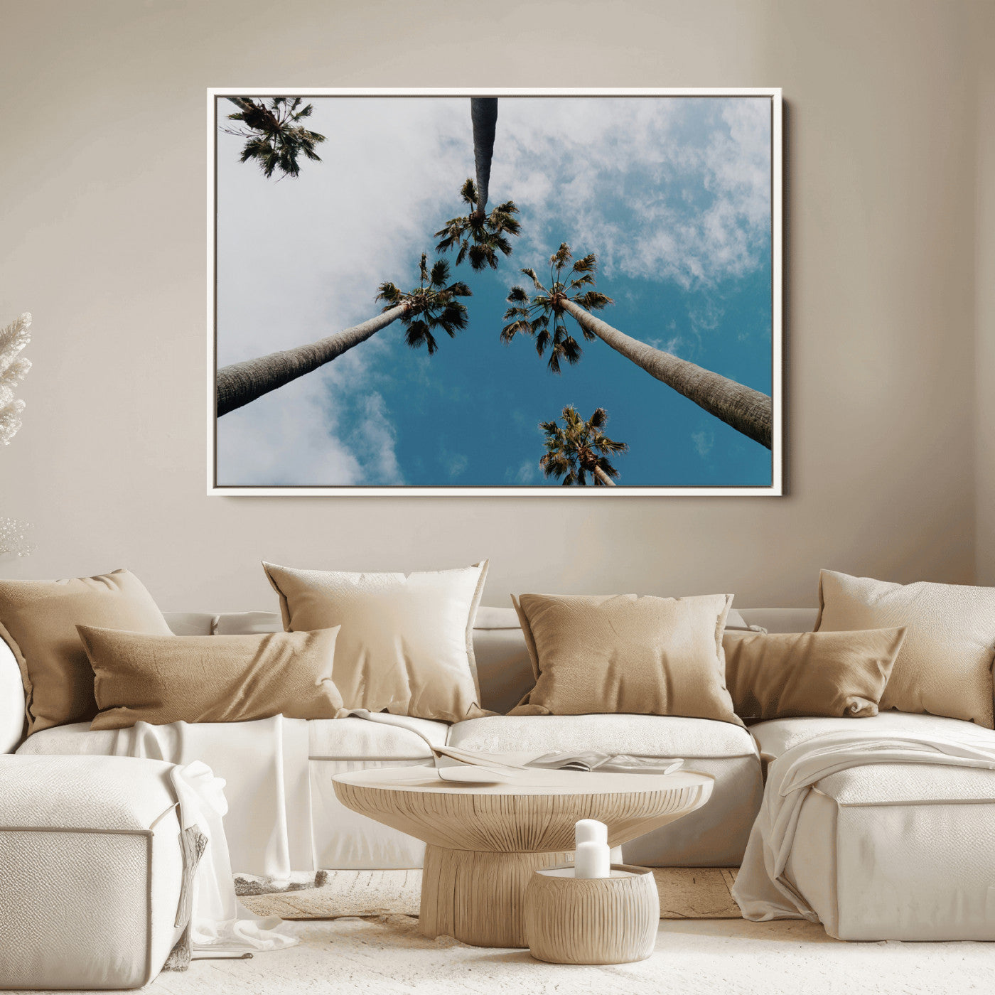 Looking up at tall palm trees against a bright blue sky with scattered clouds, creating a tropical and airy atmosphere for modern home decor.