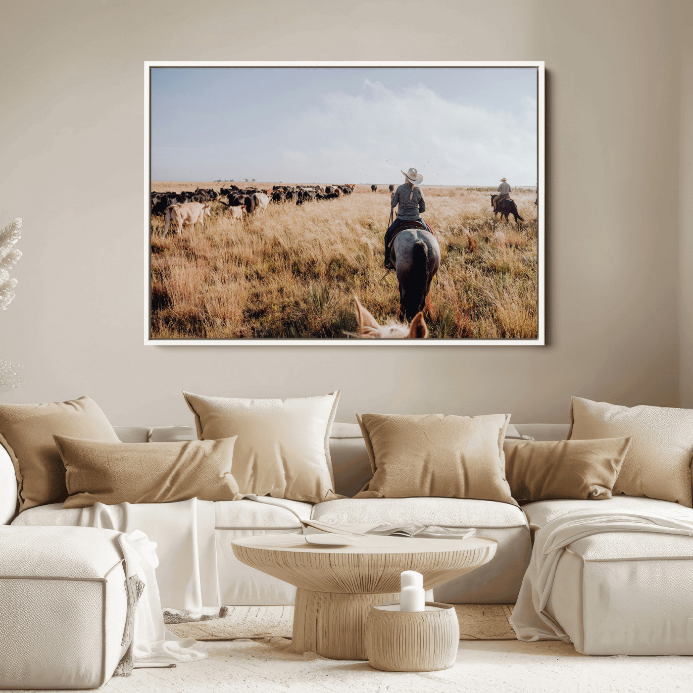 A cowboy and cowgirl on horseback herding cattle through golden grasslands, capturing a rustic and authentic Western ranch lifestyle.
