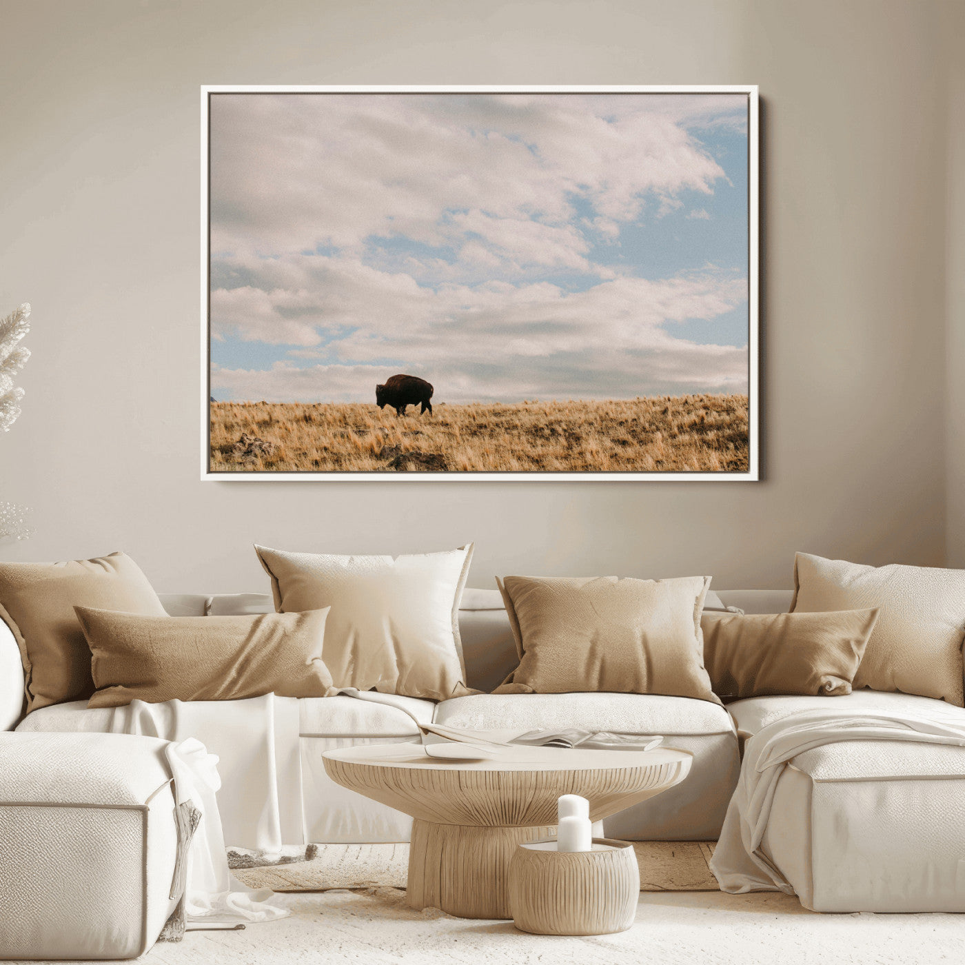 A solitary bison walking across a golden prairie under a vast, cloud-filled sky, evoking a peaceful, rustic western landscape for home decor.