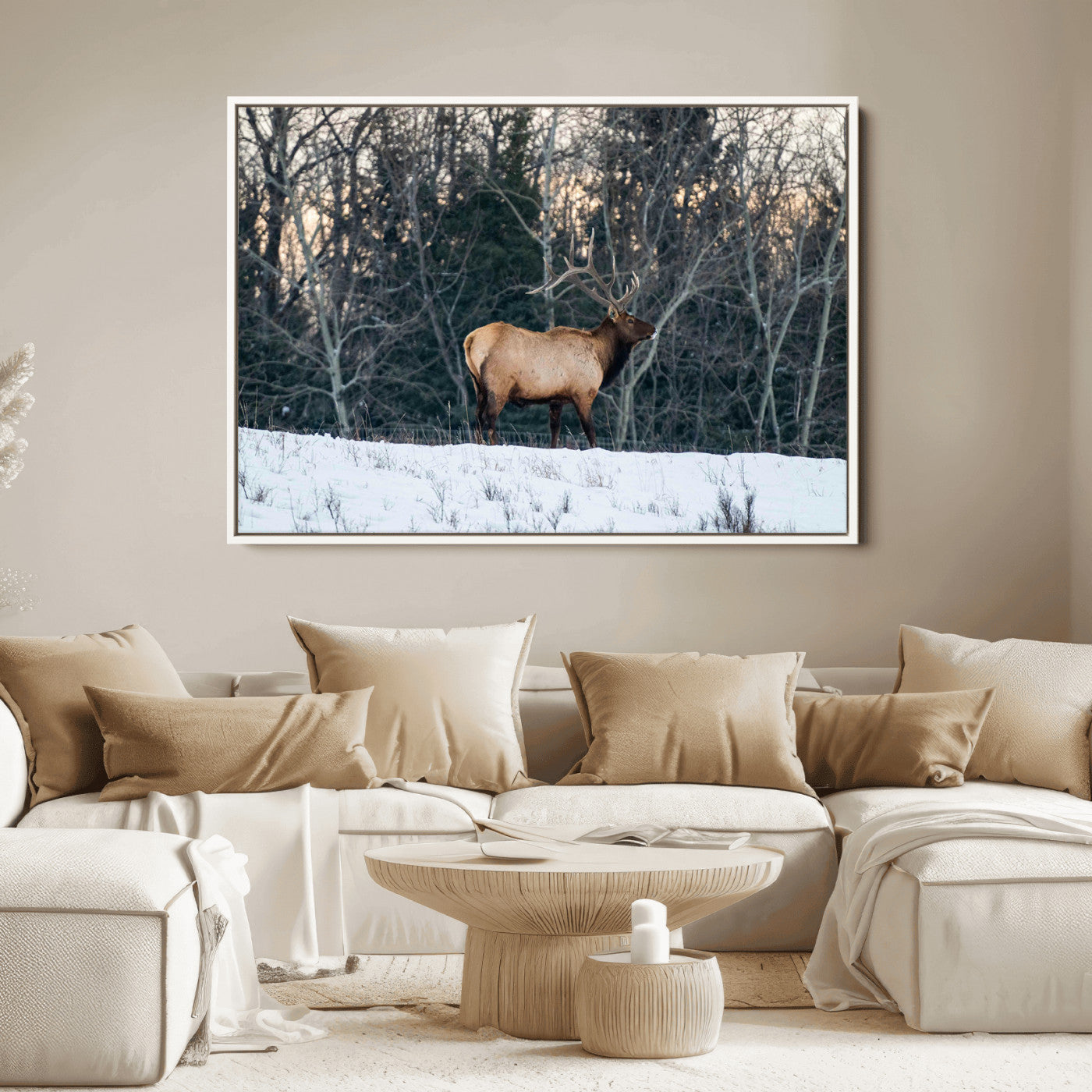 A majestic elk with large antlers standing in a snowy field against a winter forest backdrop, perfect for rustic and wildlife-themed home decor.