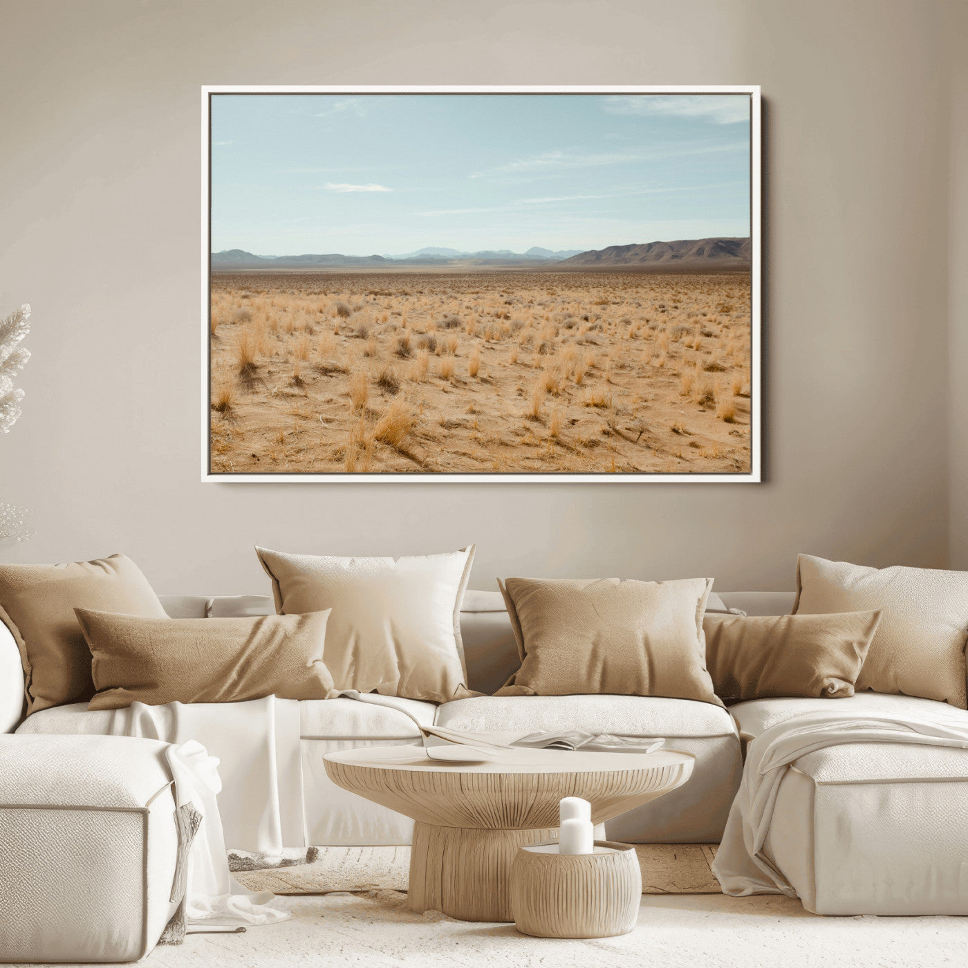 Expansive desert landscape with scattered dry grass and distant mountain range under a pale blue sky – Wall Art Canvas Print.