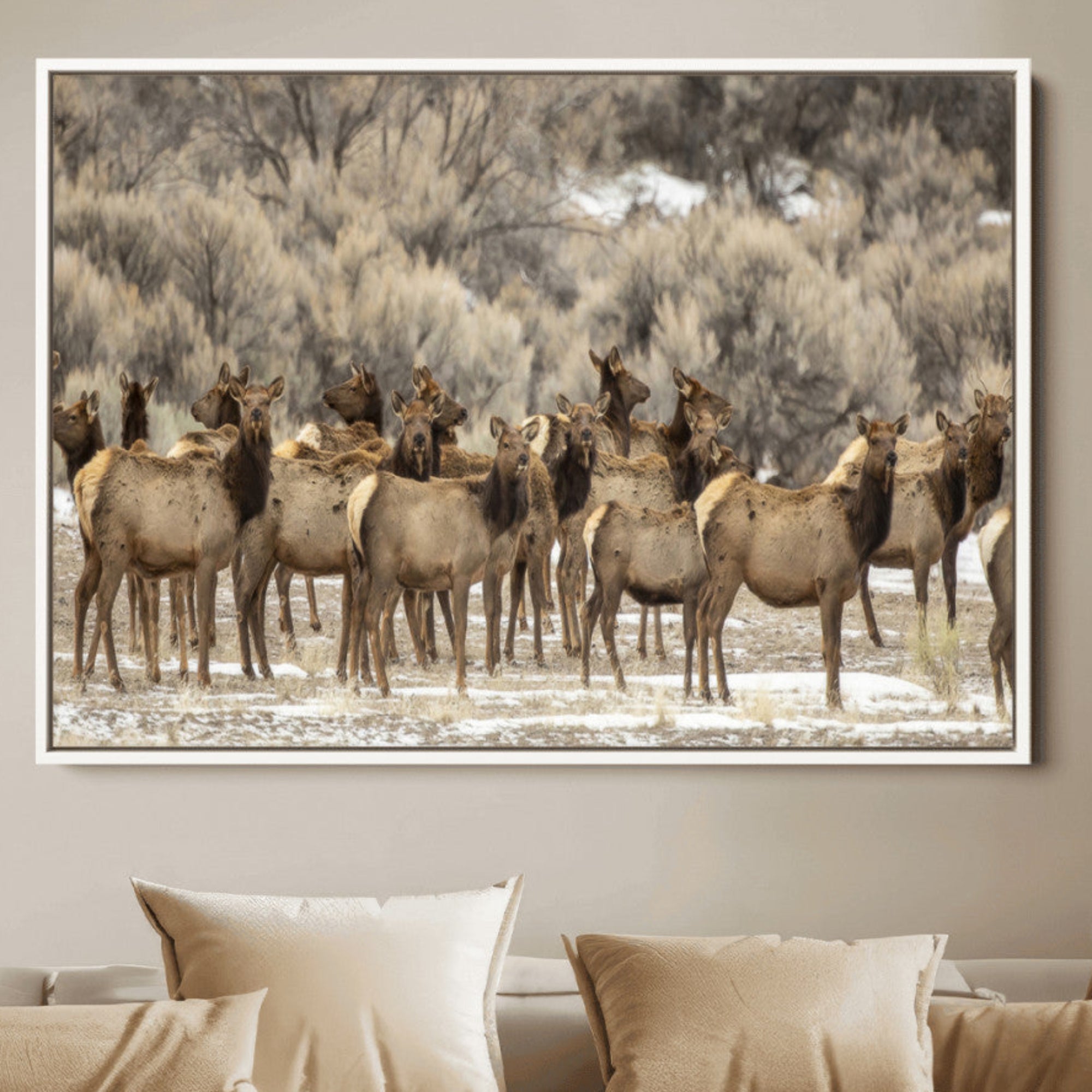 A stunning wall art canvas print featuring a large herd of elk standing together in a natural winter landscape with muted earthy tones and soft background foliage, perfect for rustic or nature-inspired home decor.