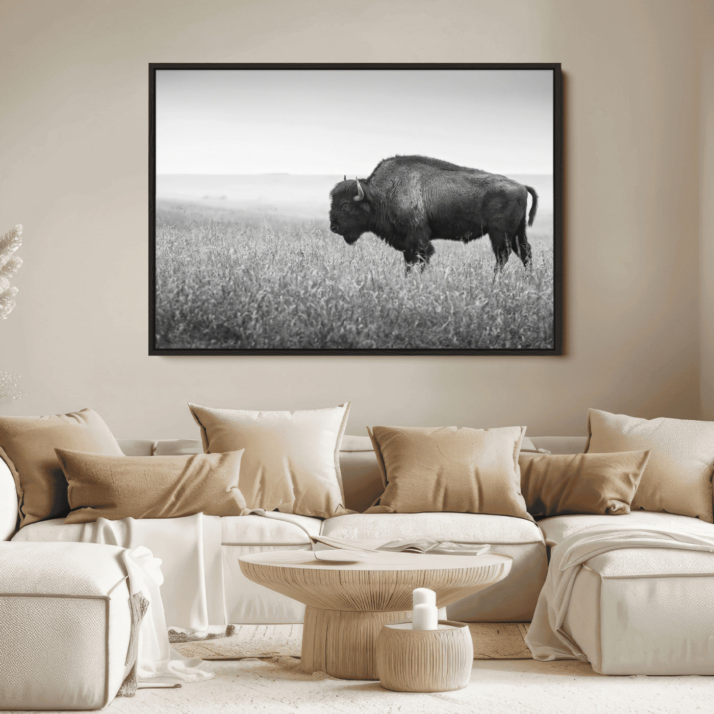 A black and white photograph of a majestic bison standing in a vast grassy prairie, evoking a sense of wilderness and strength.
