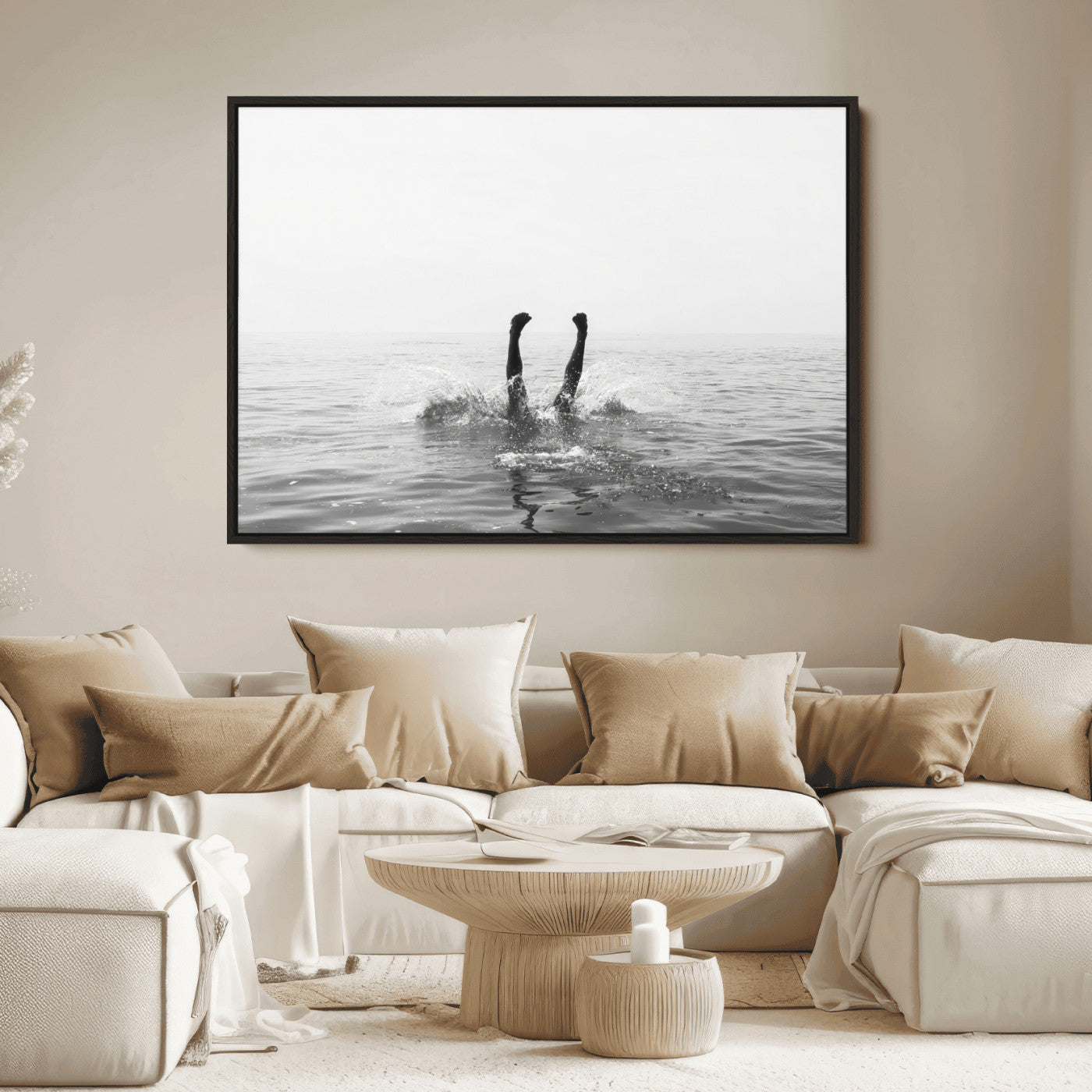 A black and white minimalist water scene capturing a playful splash as a swimmer dives upside down, creating a carefree and artistic aquatic aesthetic.