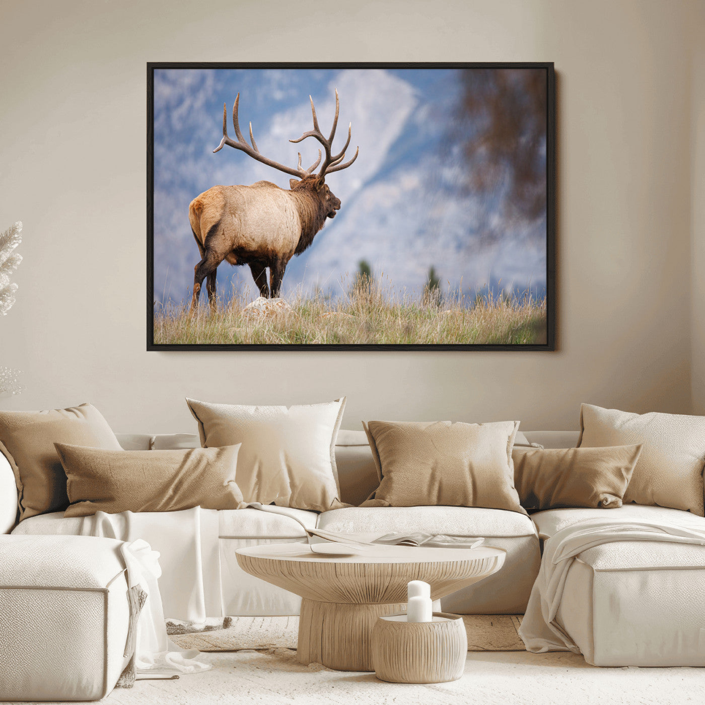 Elk with antlers standing on grass with mountain background, ideal for rustic, cabin, or lodge-inspired wall decor.