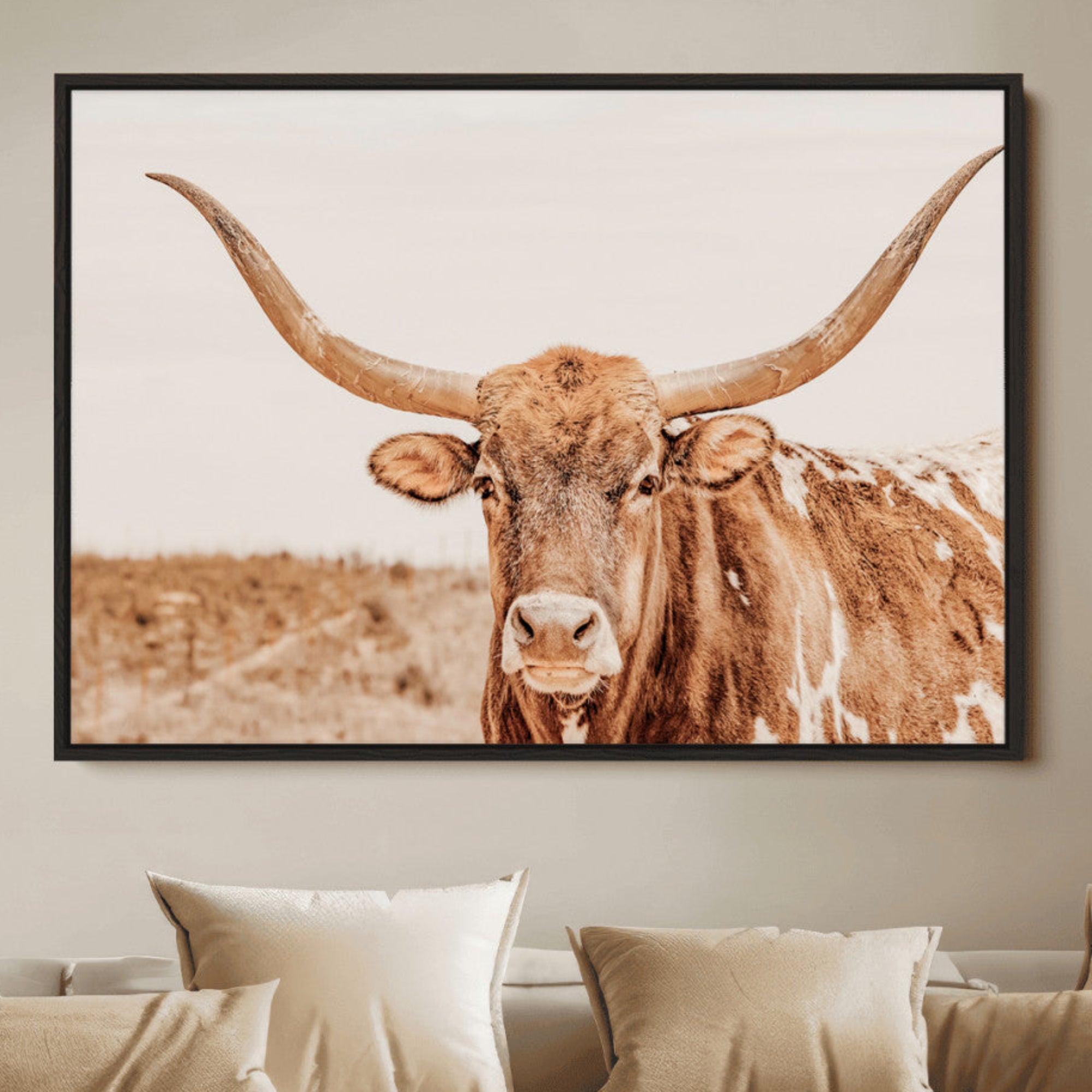 Sepia-toned Texas Longhorn facing forward in a dry field, perfect for rustic farmhouse or western-themed neutral home decor.