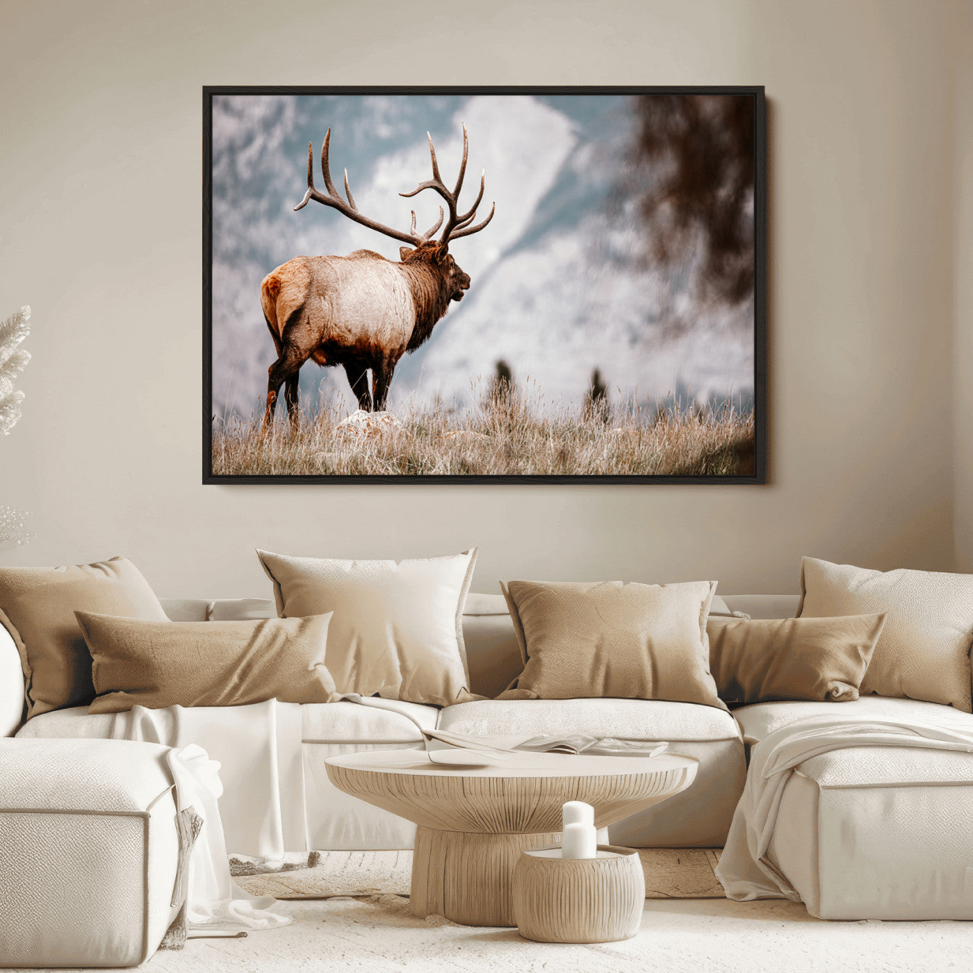 Majestic elk with large antlers standing in grass with snowy mountains in background, perfect for rustic cabin or lodge style decor.