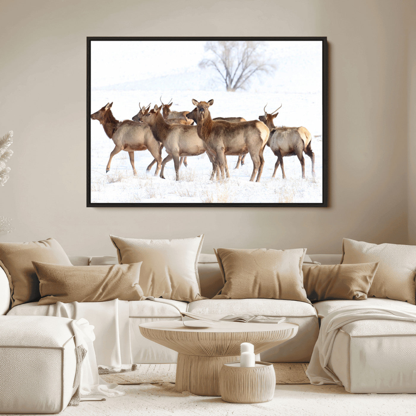 A group of elk standing on snowy terrain with a tree in the background, perfect for rustic or lodge-style winter wall decor.