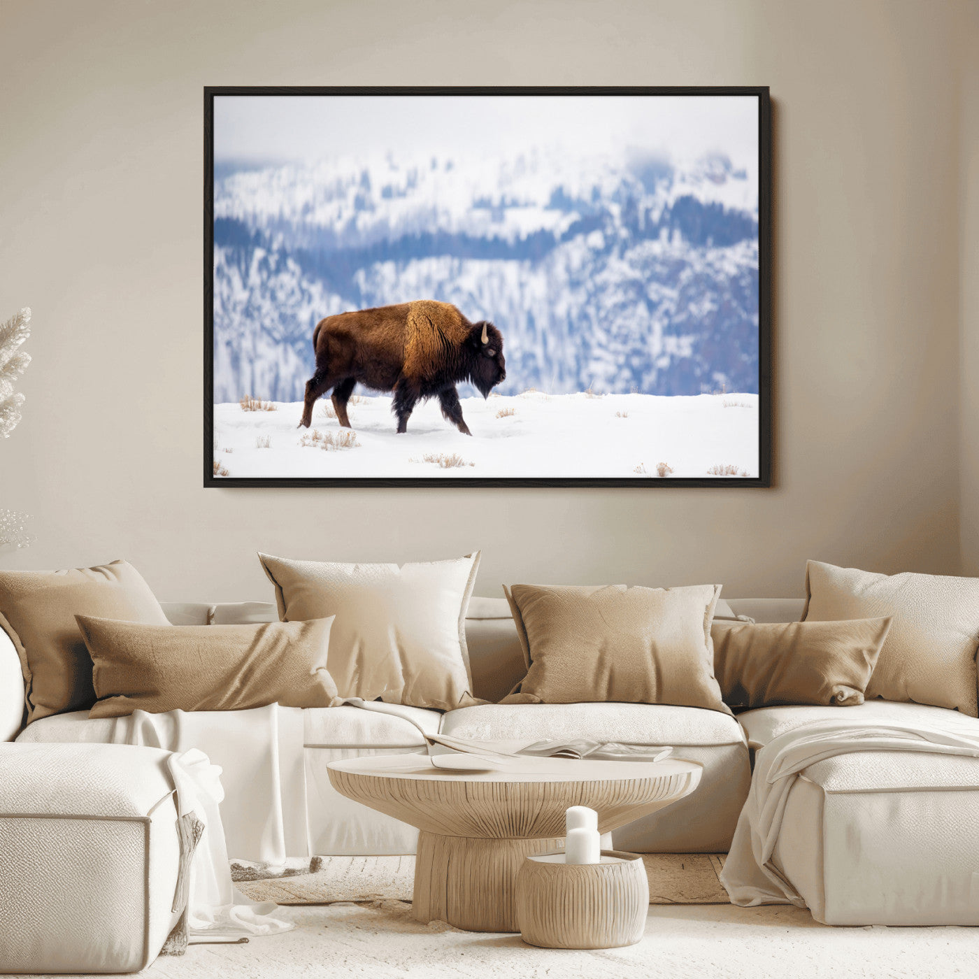 A lone bison walks across snowy ground with blue-toned mountain range behind, ideal for rustic or western farmhouse interiors.