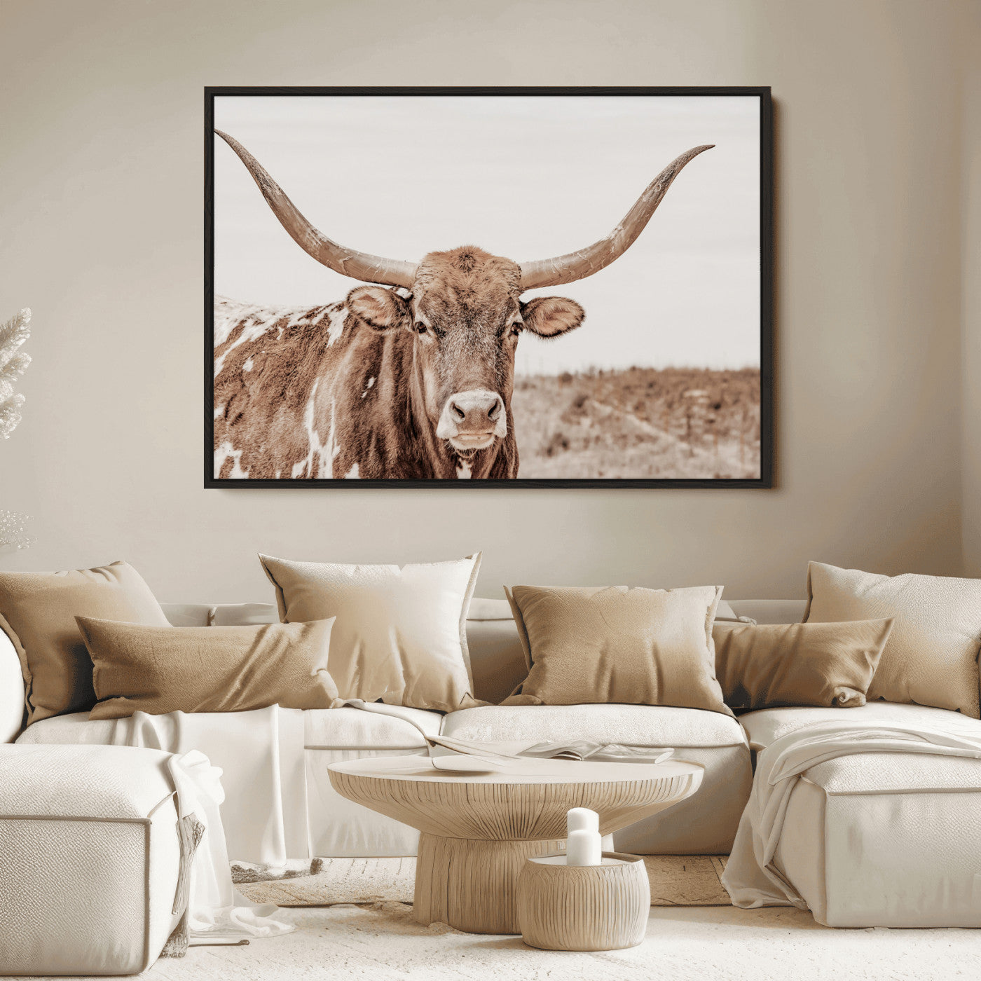 A longhorn cow in soft beige desert tones, standing calmly in open land, perfect for neutral western or rustic farmhouse interiors.